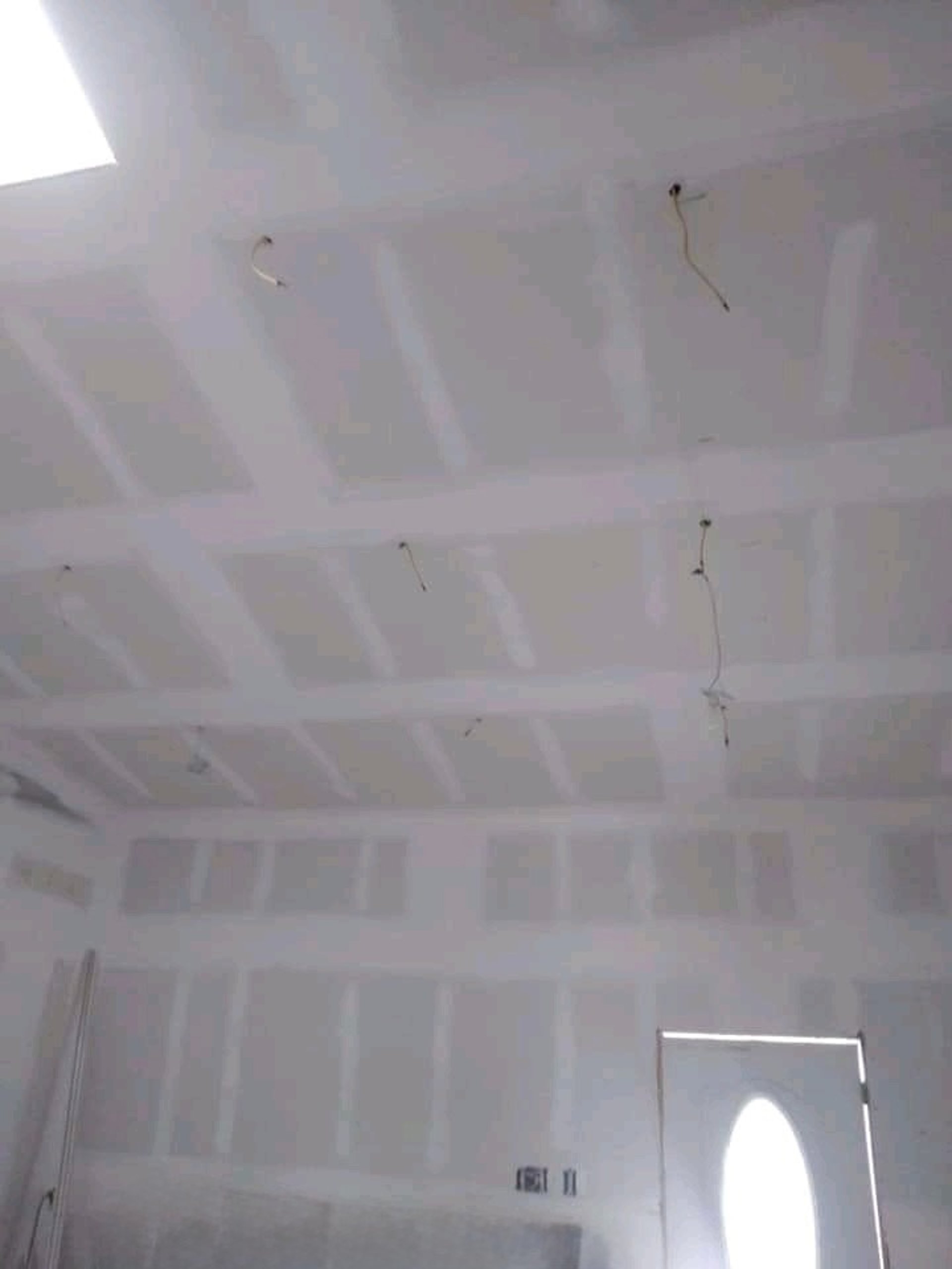 an abstract photo of a curved building with a blue sky in the background