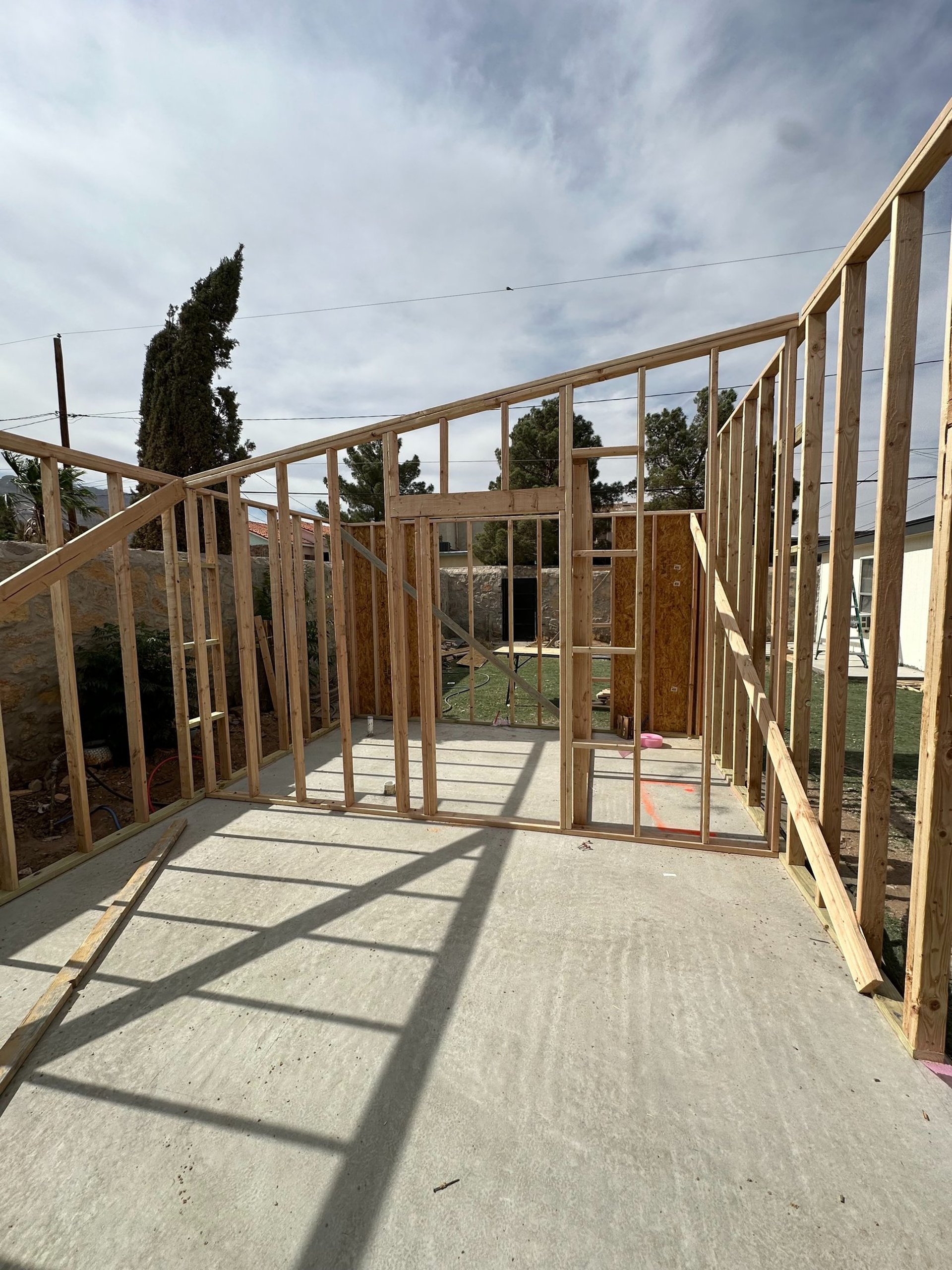 an abstract photo of a curved building with a blue sky in the background