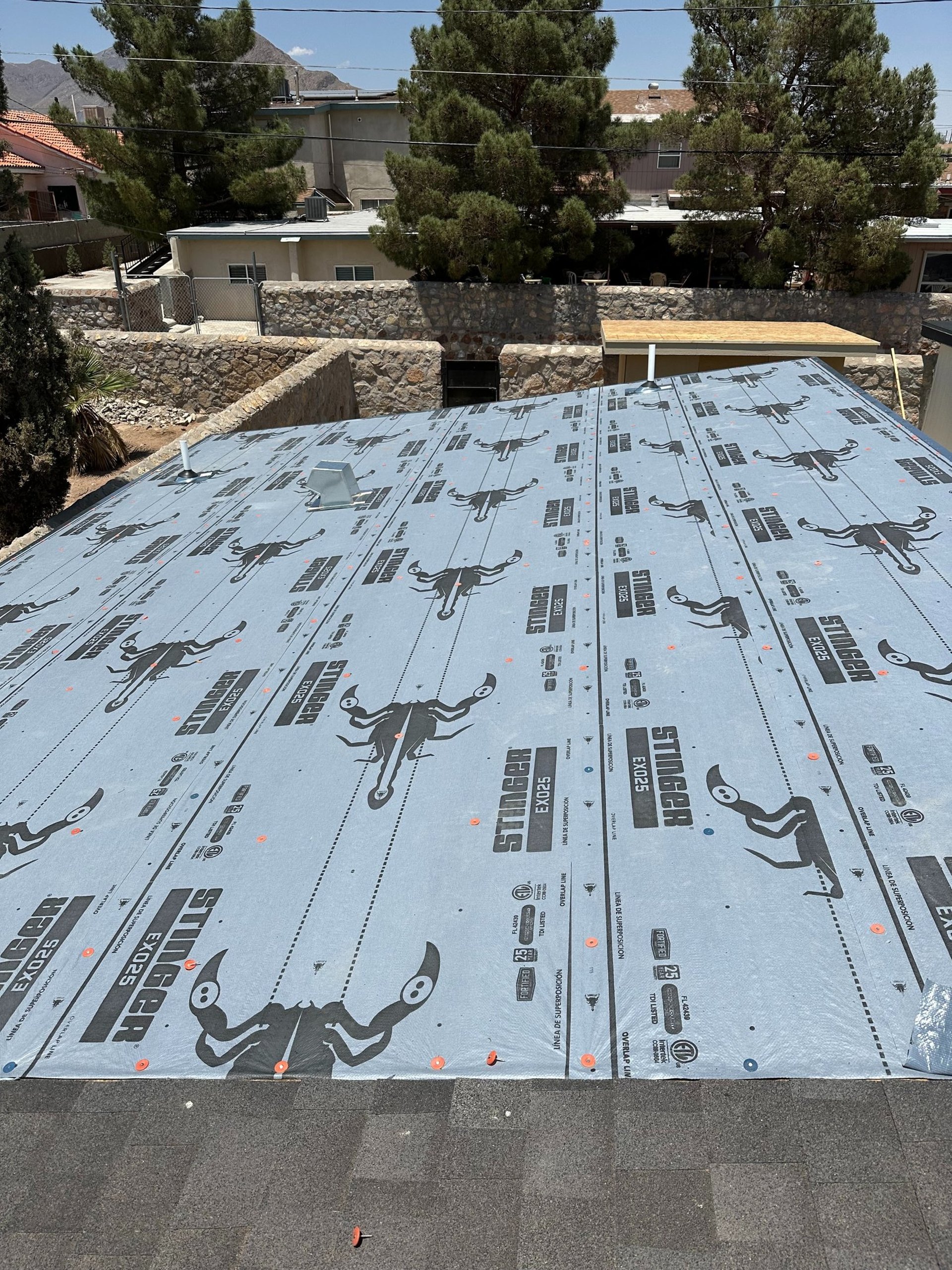 an abstract photo of a curved building with a blue sky in the background