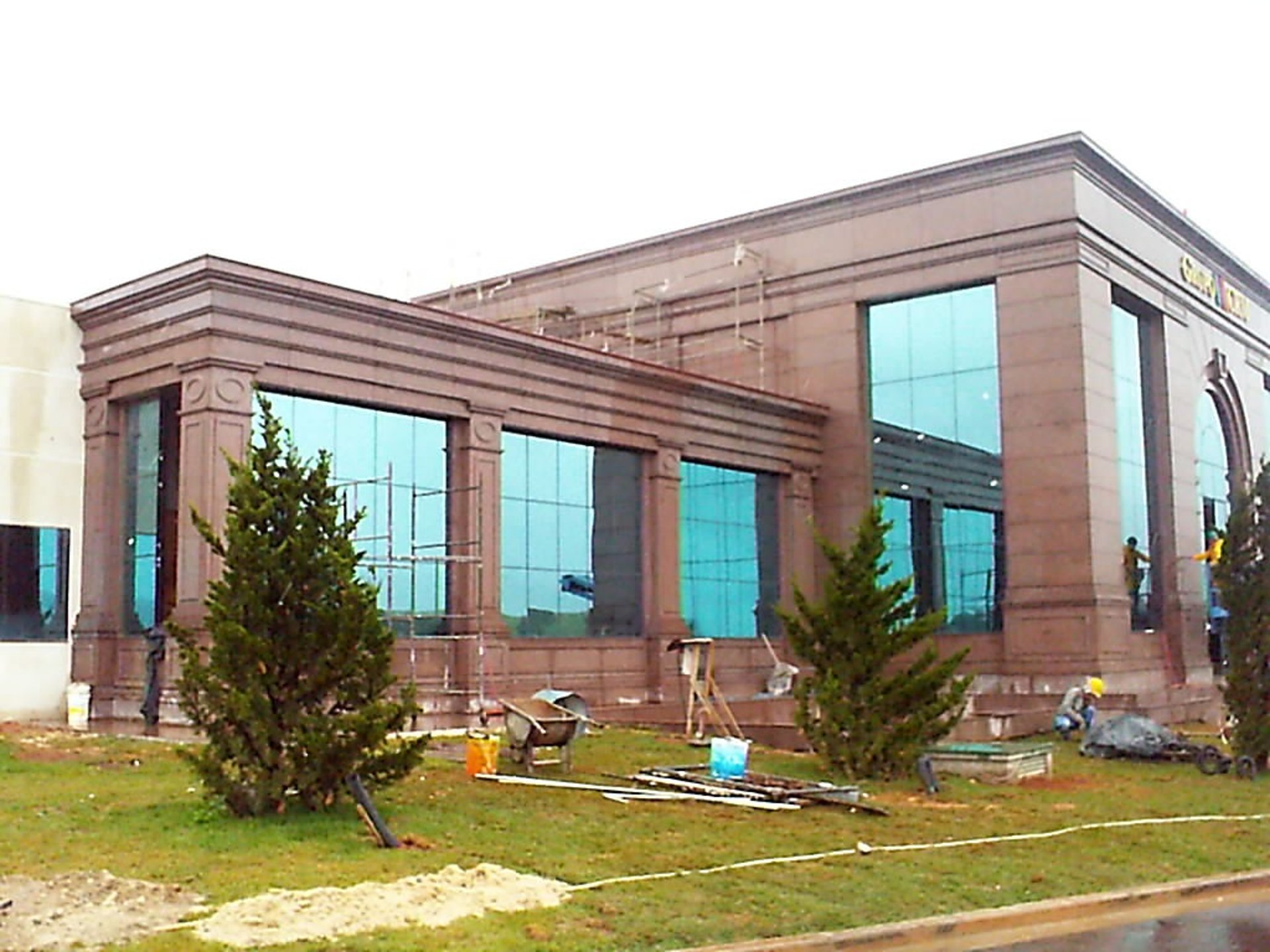 A person in yellow gloves and blue gloves cleaning a floor