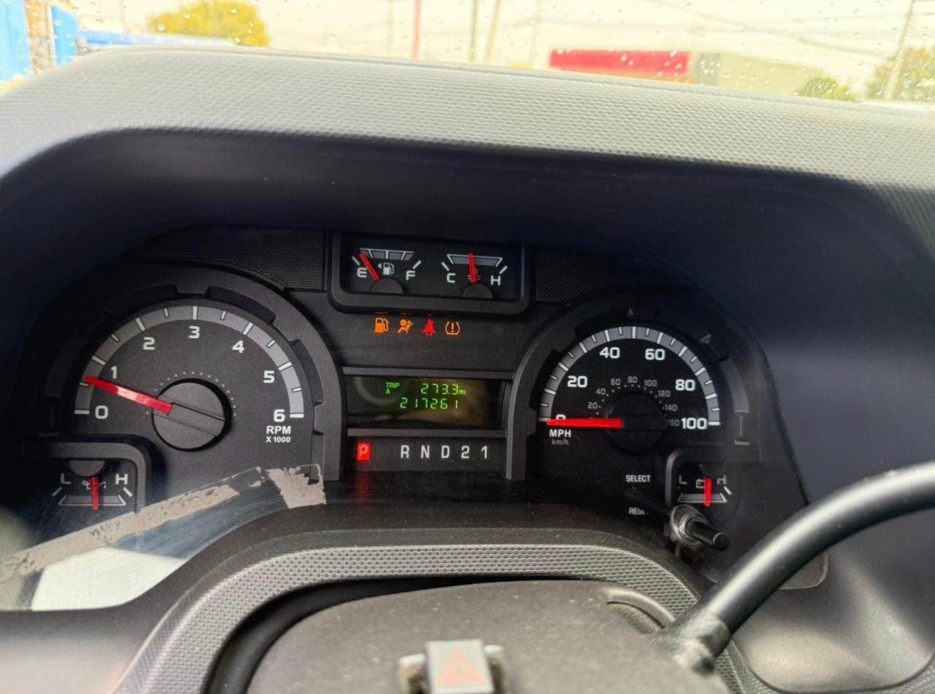 white and brown concrete building near green grass field during daytime