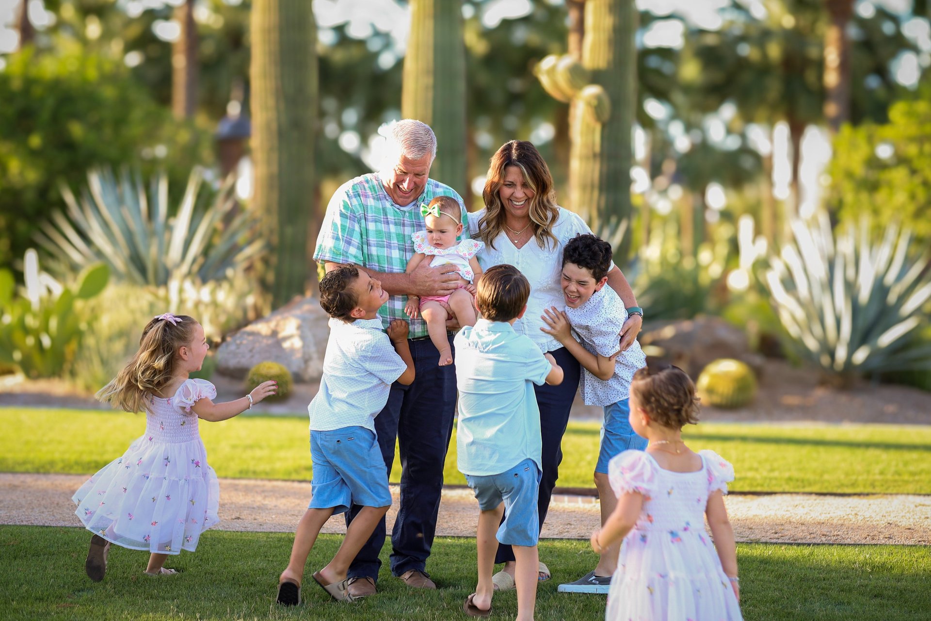 Grandparents smiling with their grandchildren during an outdoor family photography session in Arizona.
