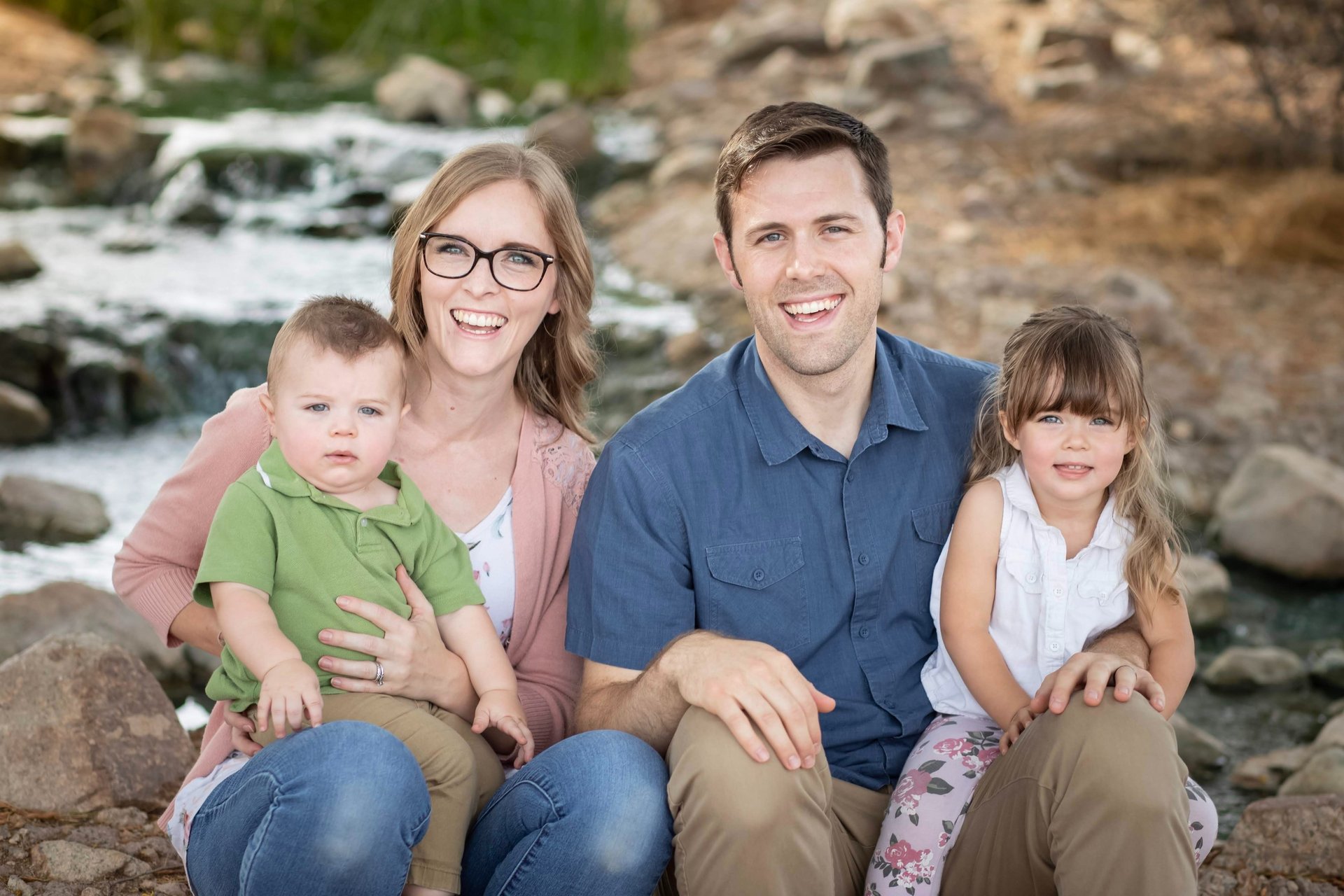 Family sitting together outdoors for a natural family portrait session in Gilbert, Arizona.