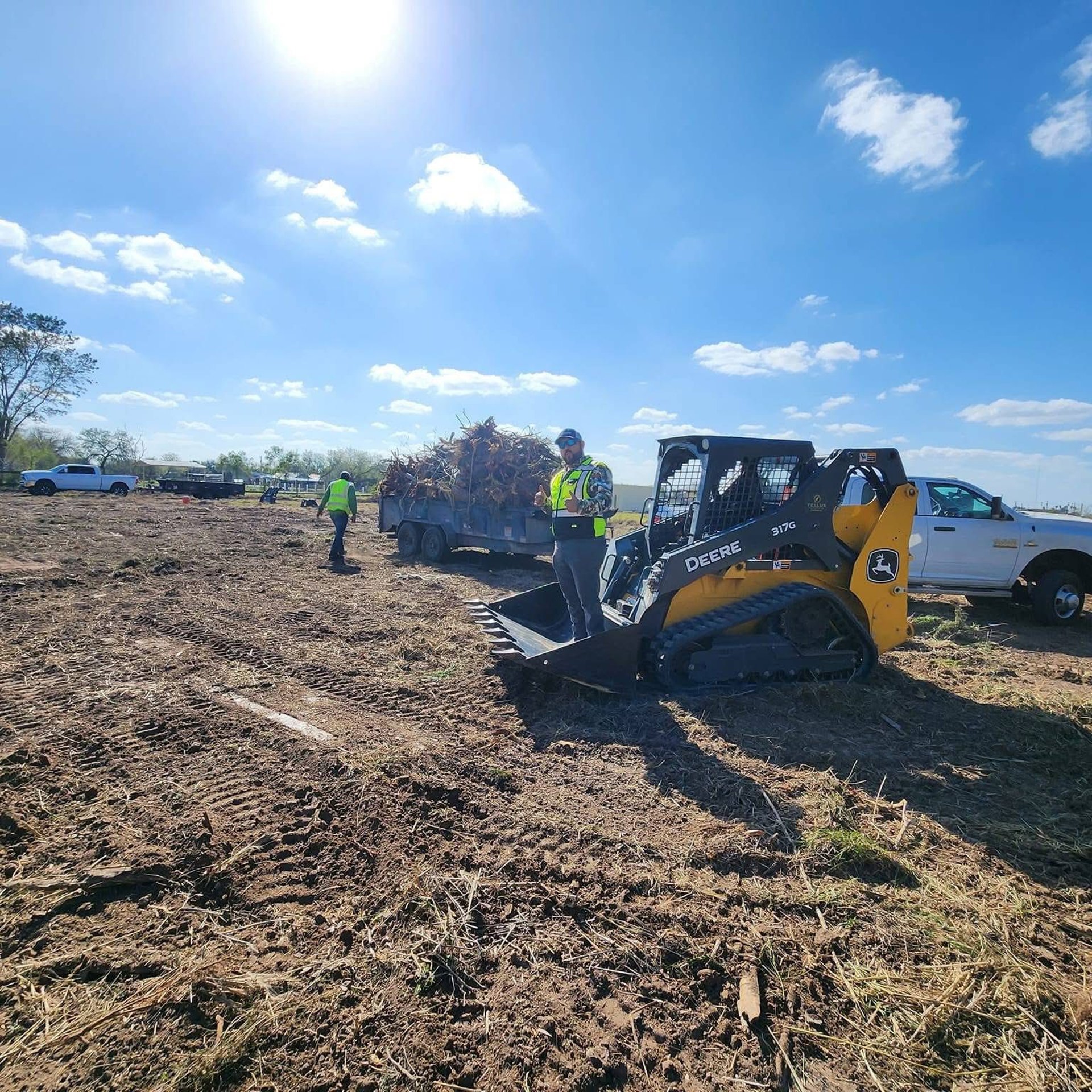 A tree arborist is cutting a branch.