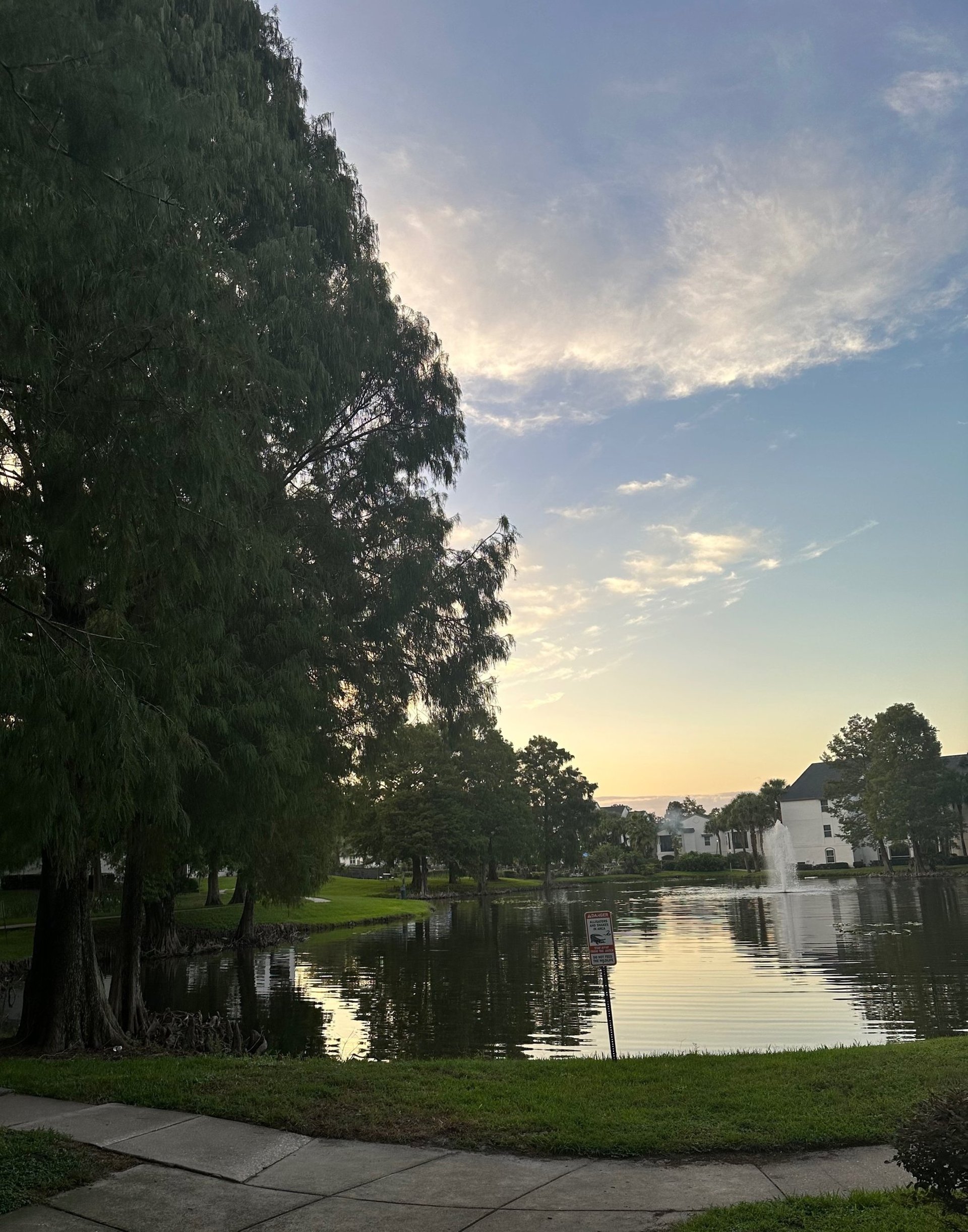 woman wearing yellow long-sleeved dress under white clouds and blue sky during daytime