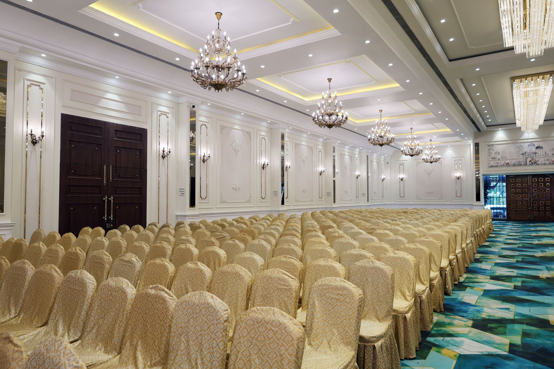 a banquet room with white tables and white chairs