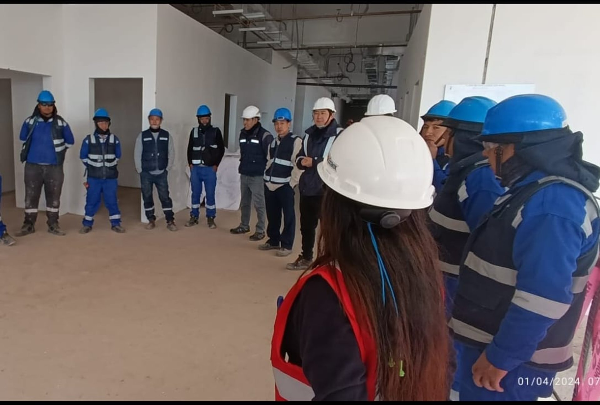 group of people wearing orange and yellow safety vest