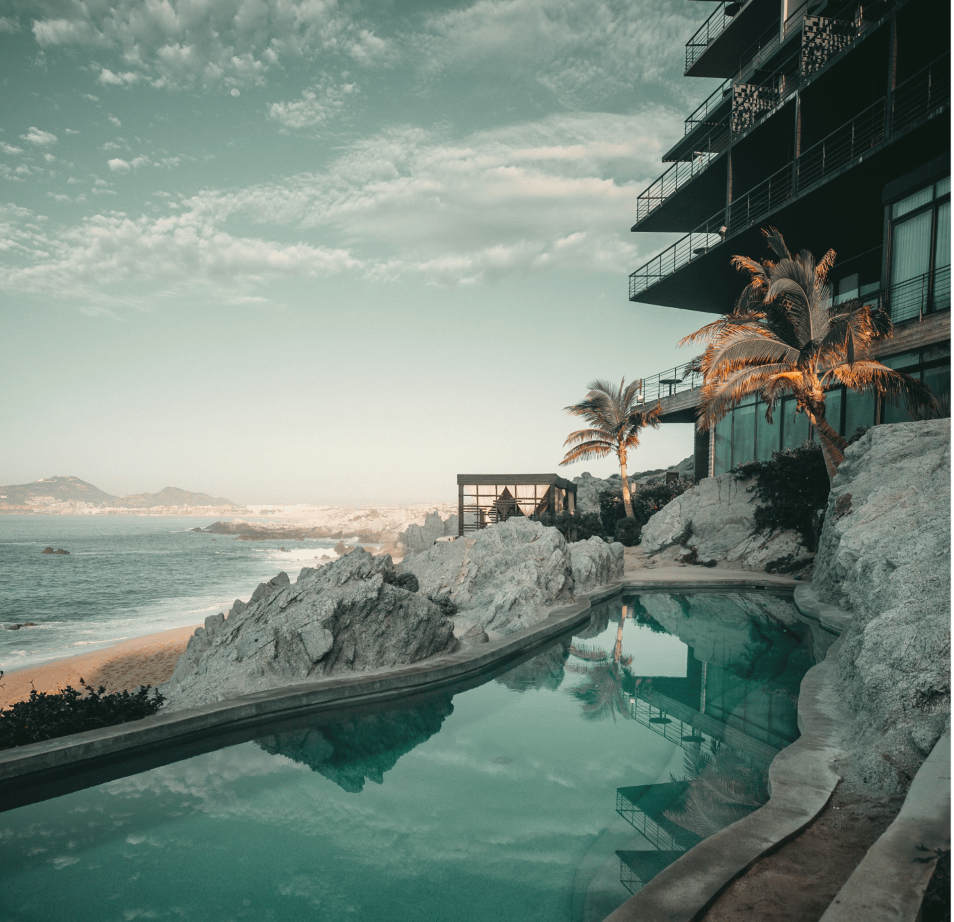 an abstract photo of a curved building with a blue sky in the background