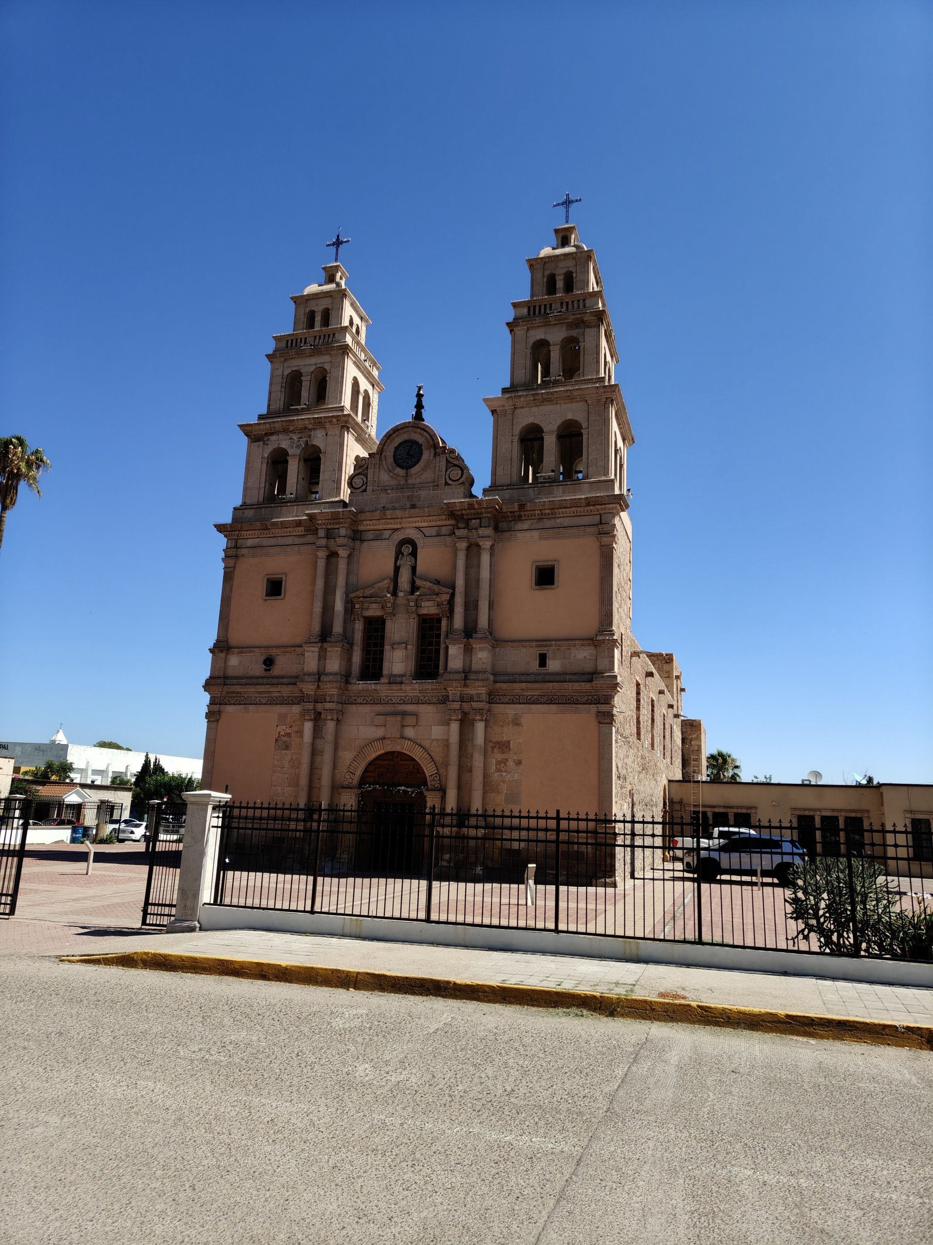 an abstract photo of a curved building with a blue sky in the background