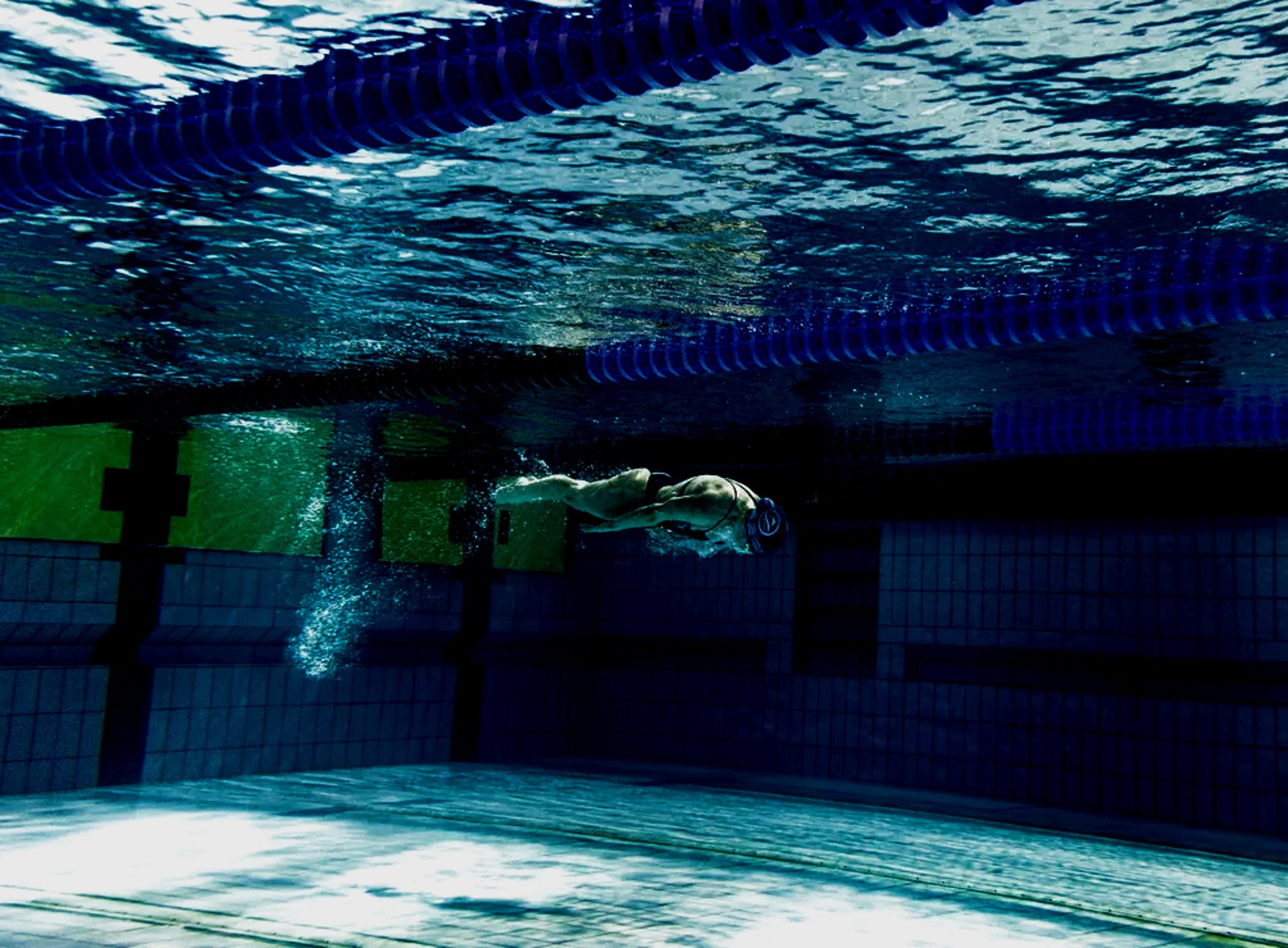 an abstract photo of a curved building with a blue sky in the background