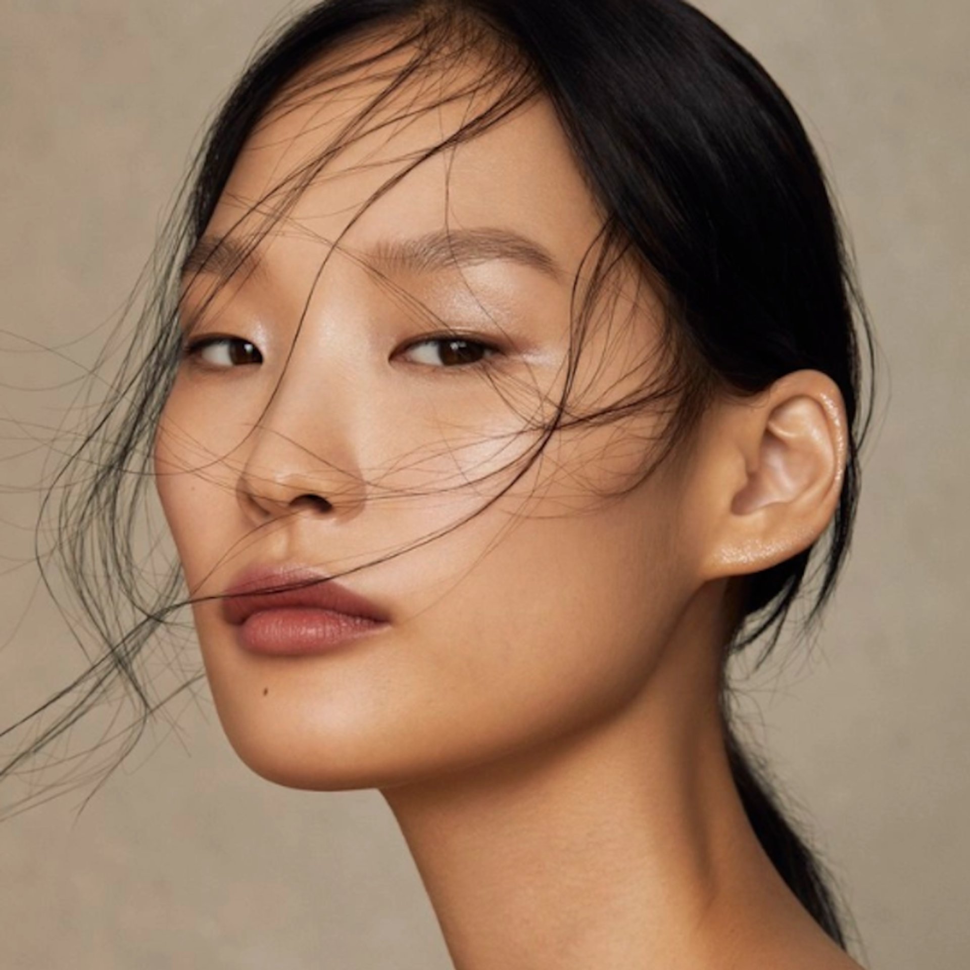 an abstract photo of a curved building with a blue sky in the background