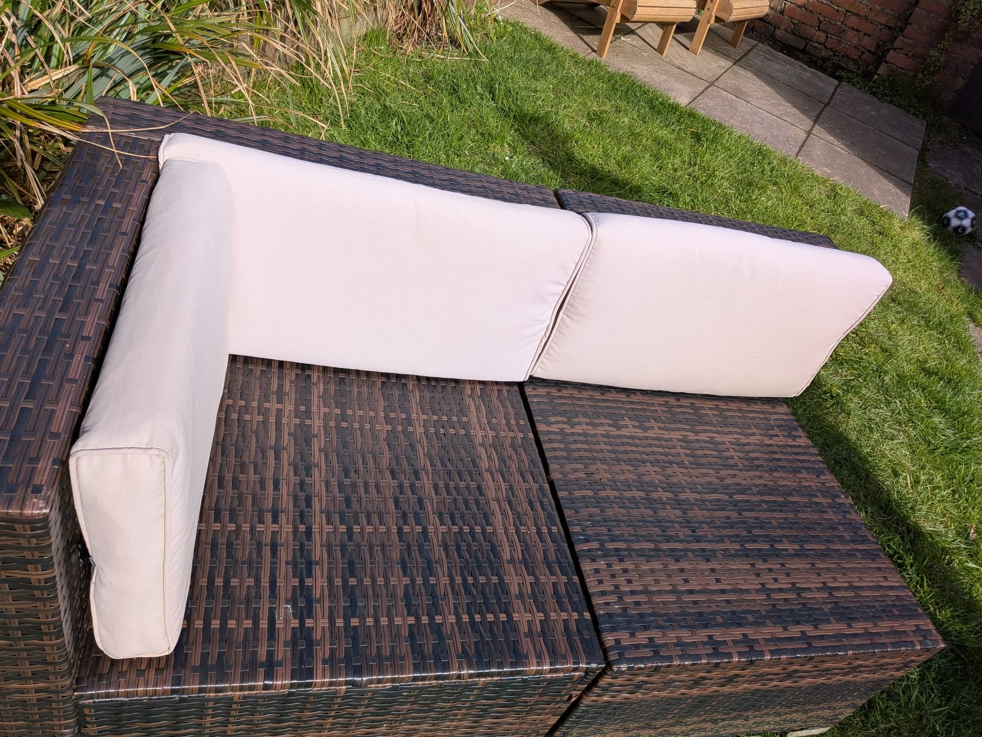 Rattan cushion clip in use on rattan furniture