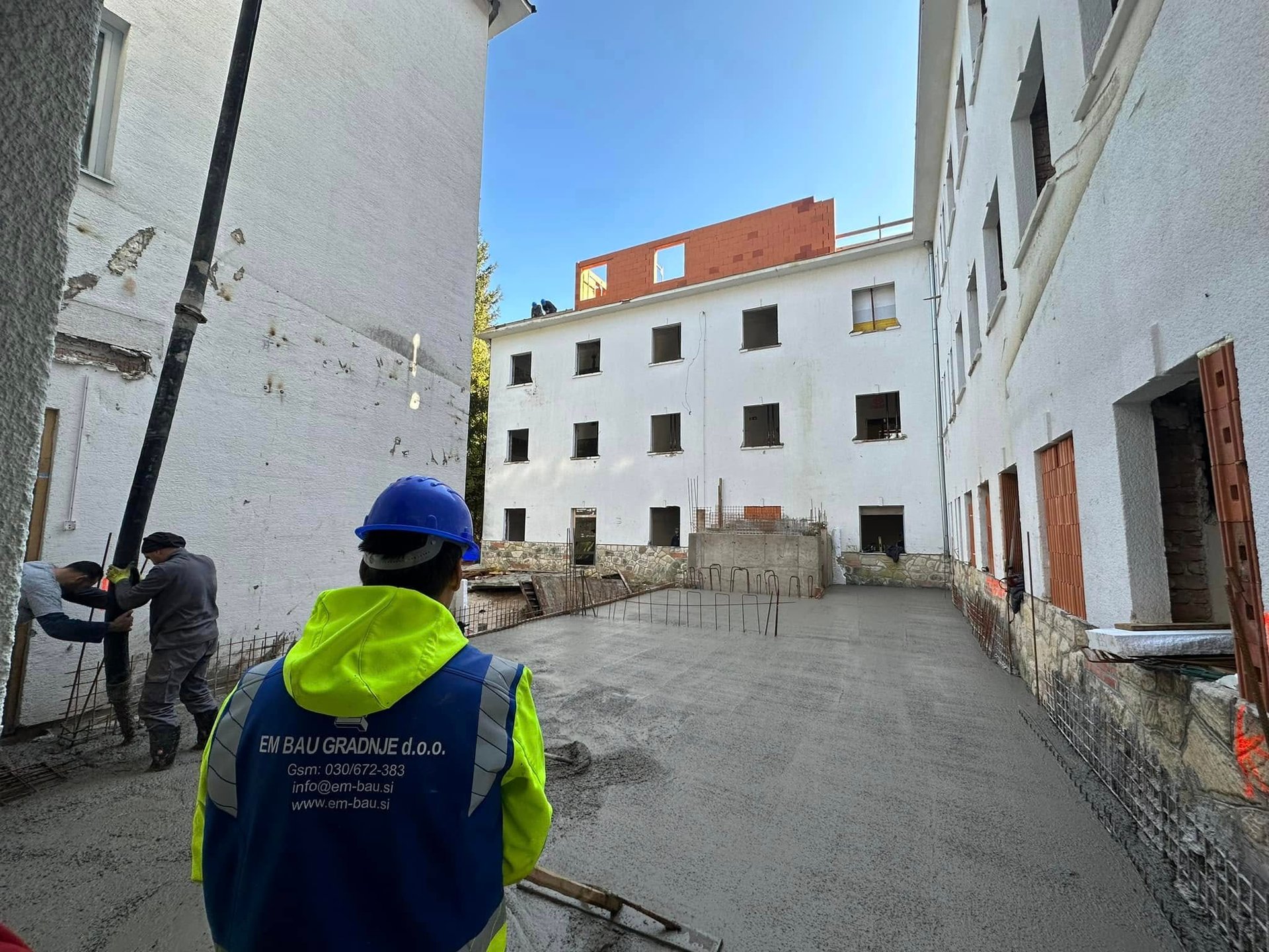 man in white hard hat standing on brown wooden dock during daytime