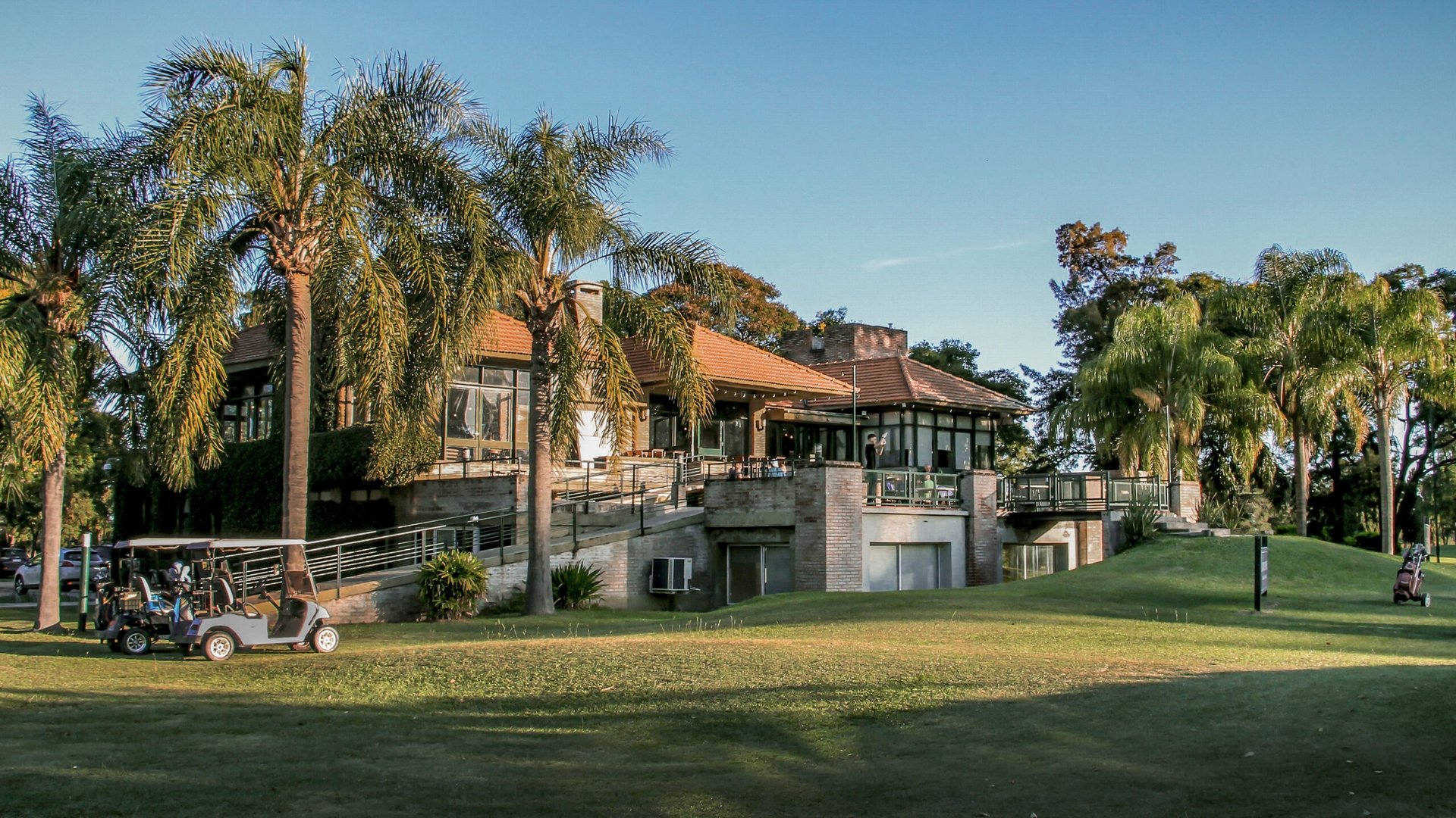 woman wearing yellow long-sleeved dress under white clouds and blue sky during daytime
