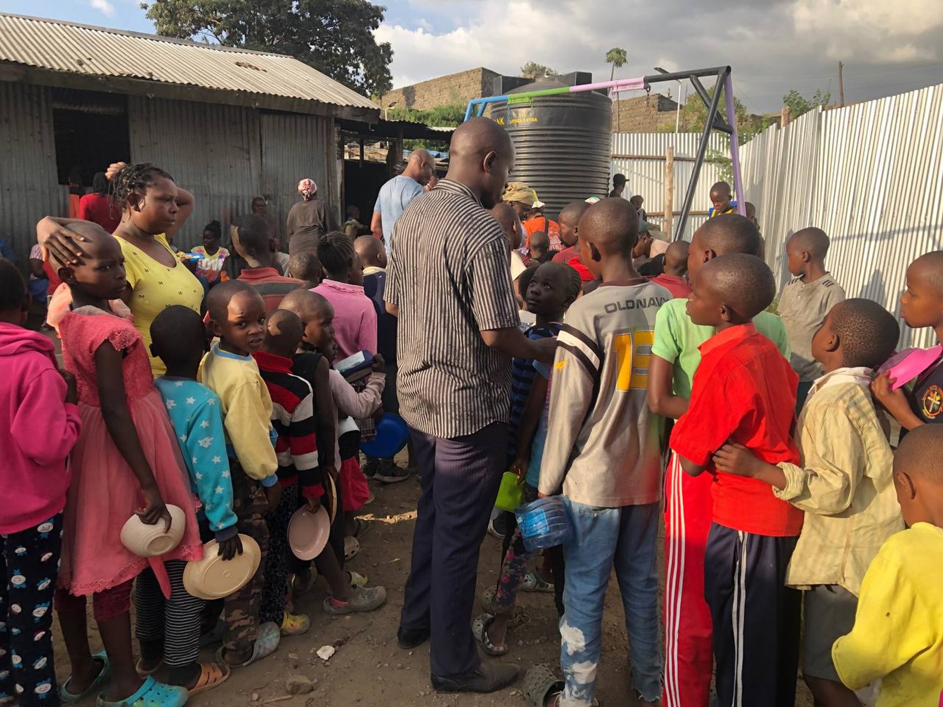 woman wearing yellow long-sleeved dress under white clouds and blue sky during daytime