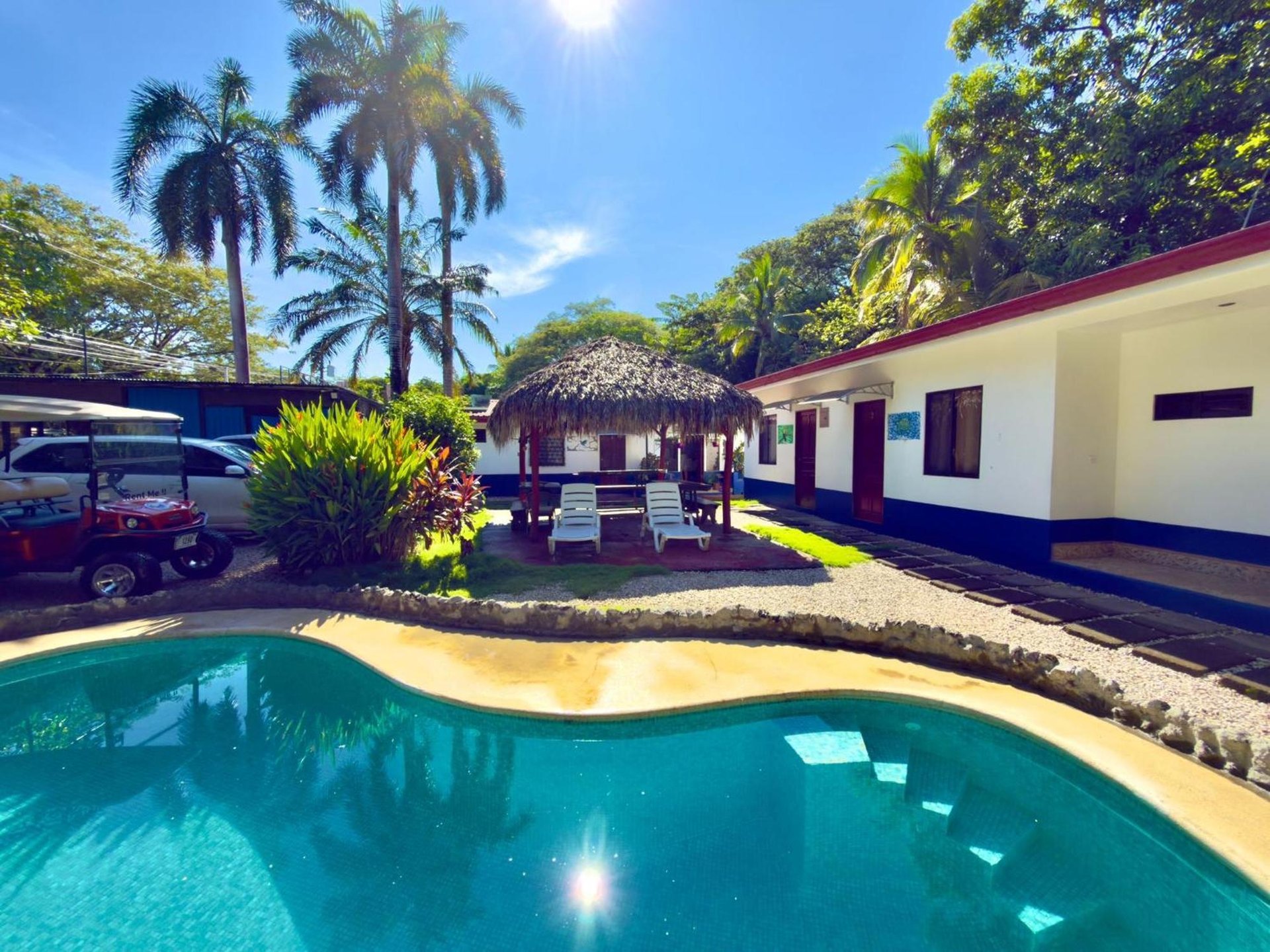 an abstract photo of a curved building with a blue sky in the background