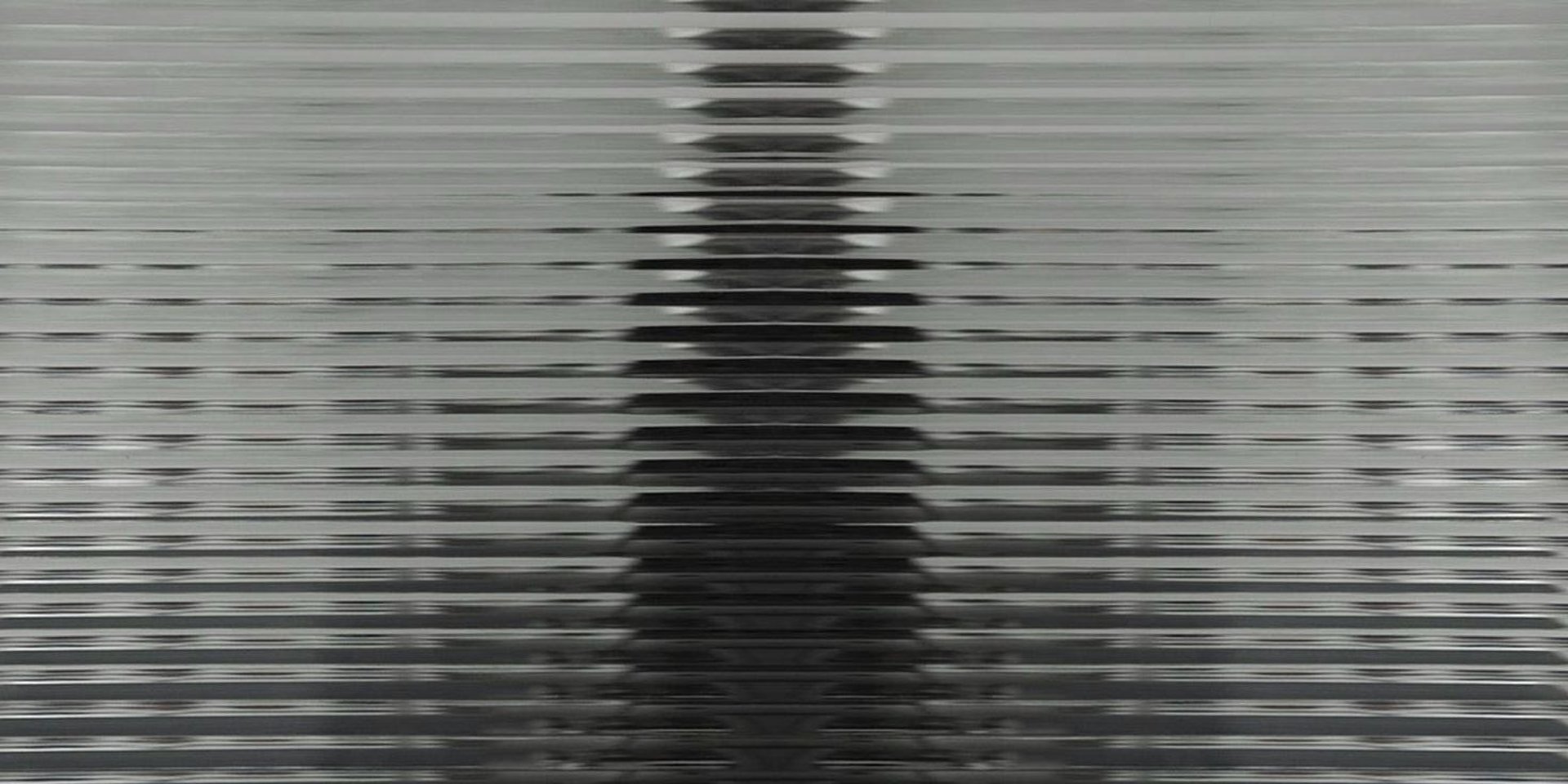 an abstract photo of a curved building with a blue sky in the background