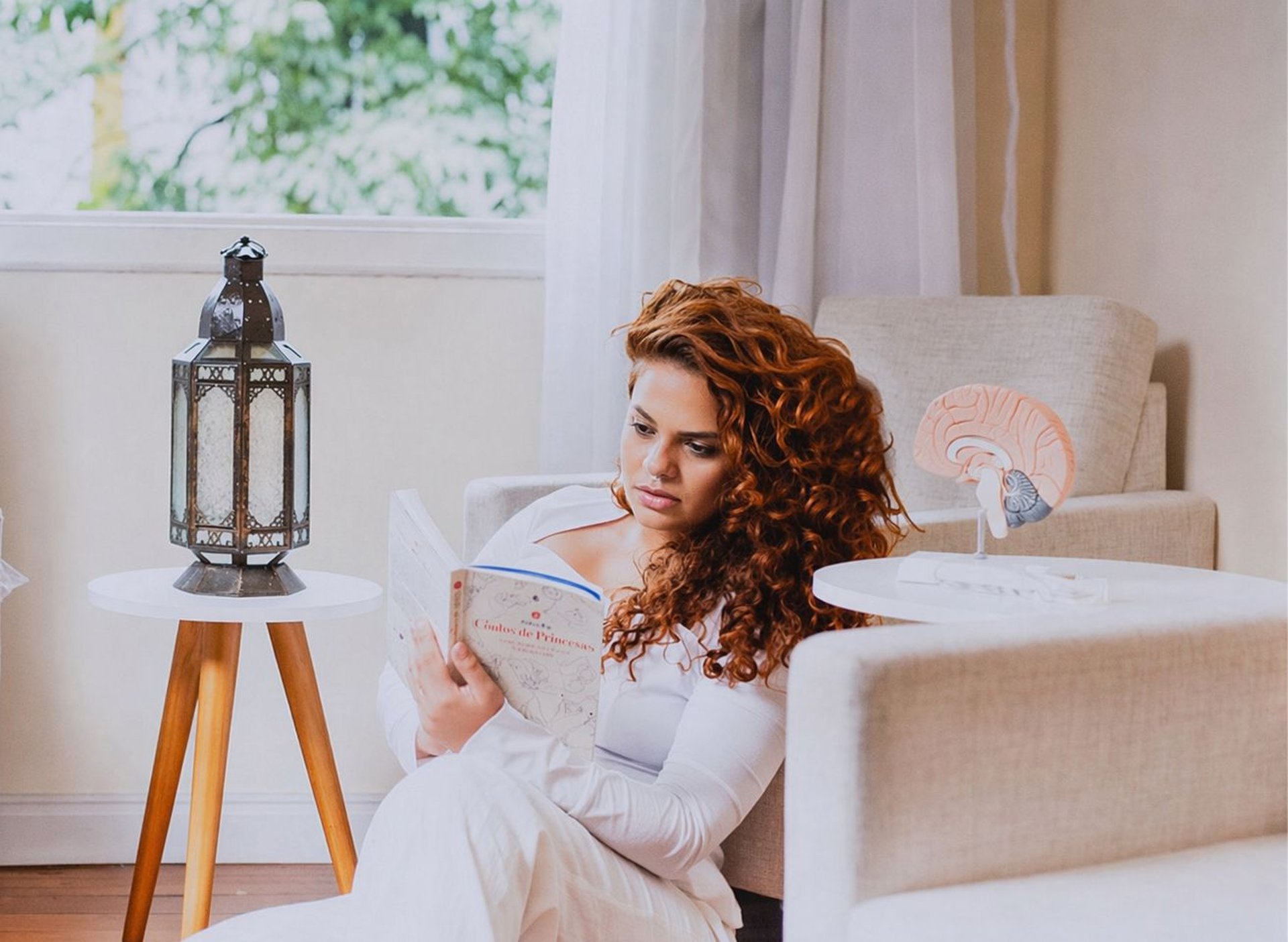 Hands massaging a person's forearm with gentle pressure.