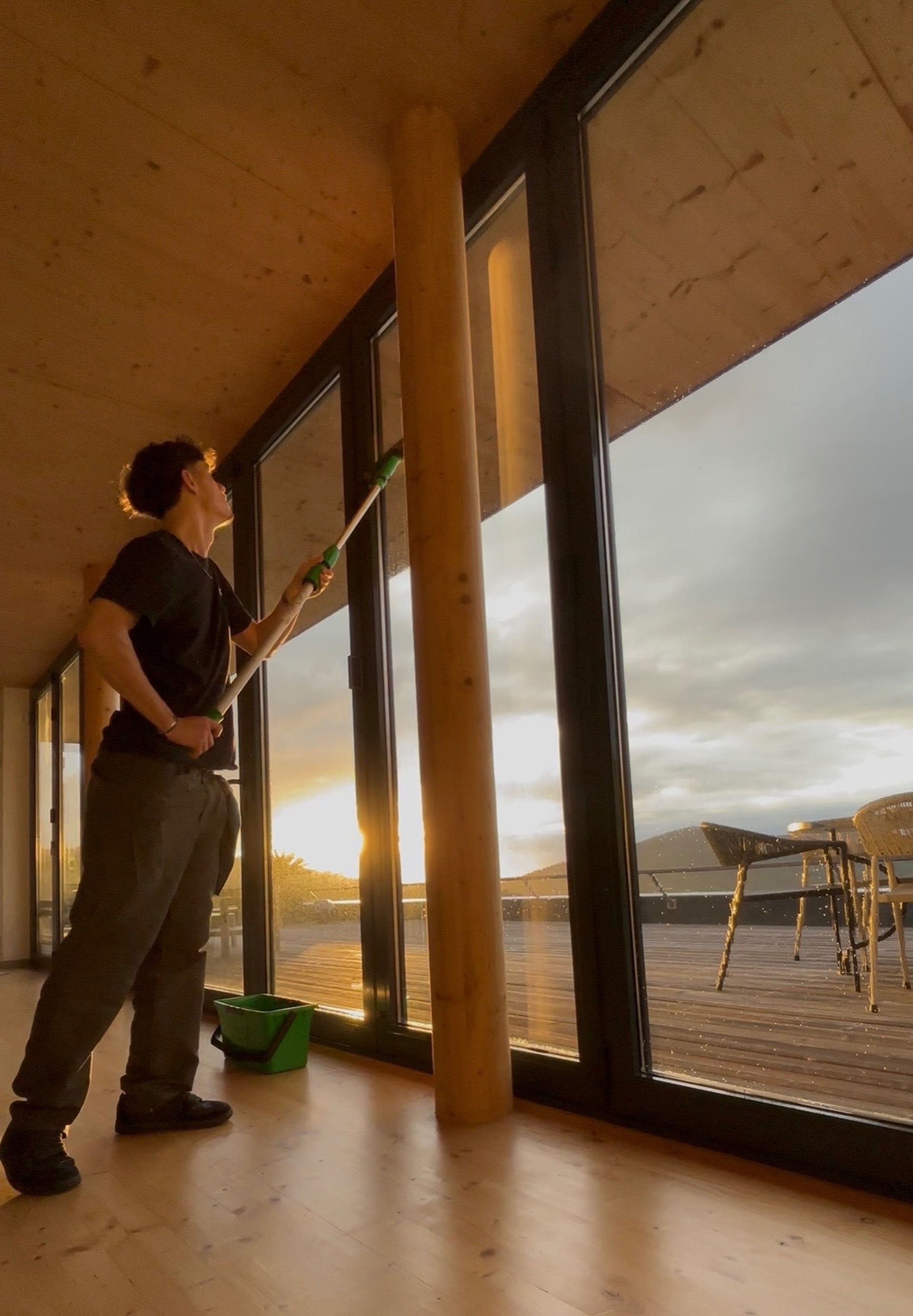 A person looks out a glass door.