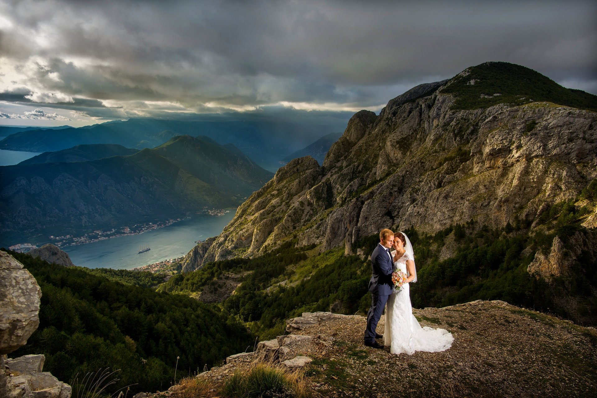 Romantic wedding photoshoot Kotor Boka Bay mountains - Bride and groom at sunset overlooking Bay of Kotor Montenegro