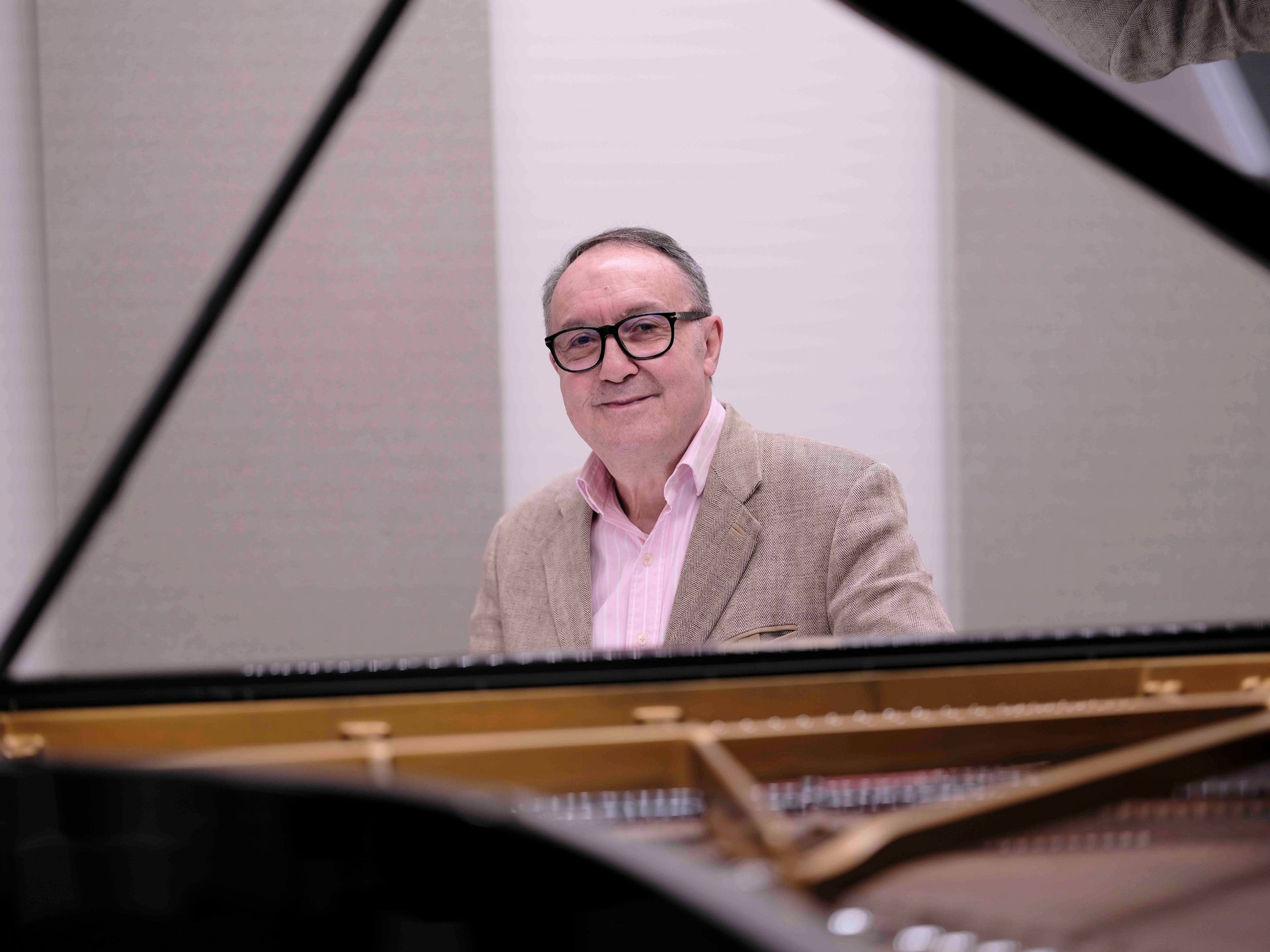 an abstract photo of a curved building with a blue sky in the background