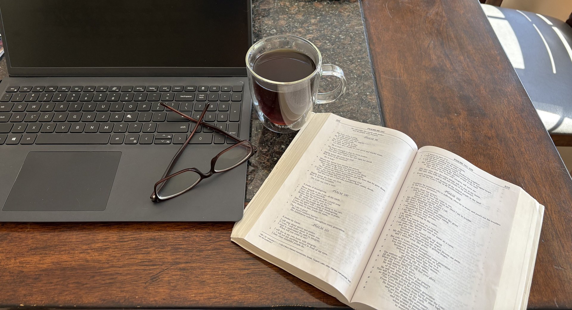 a cup of coffee and a pen on a table