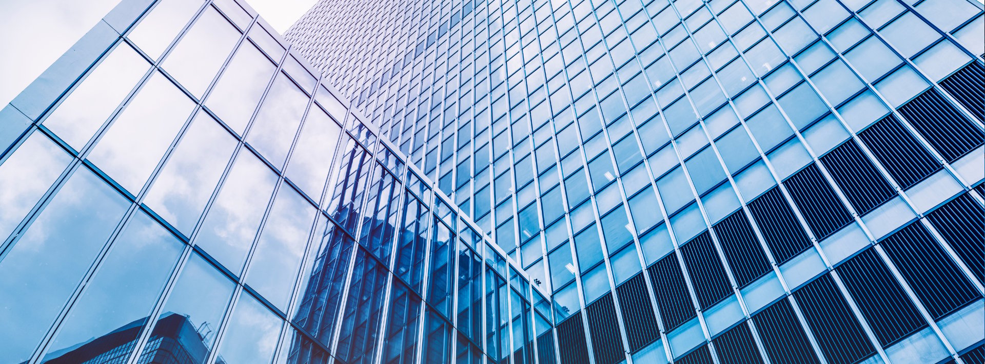 an abstract photo of a curved building with a blue sky in the background