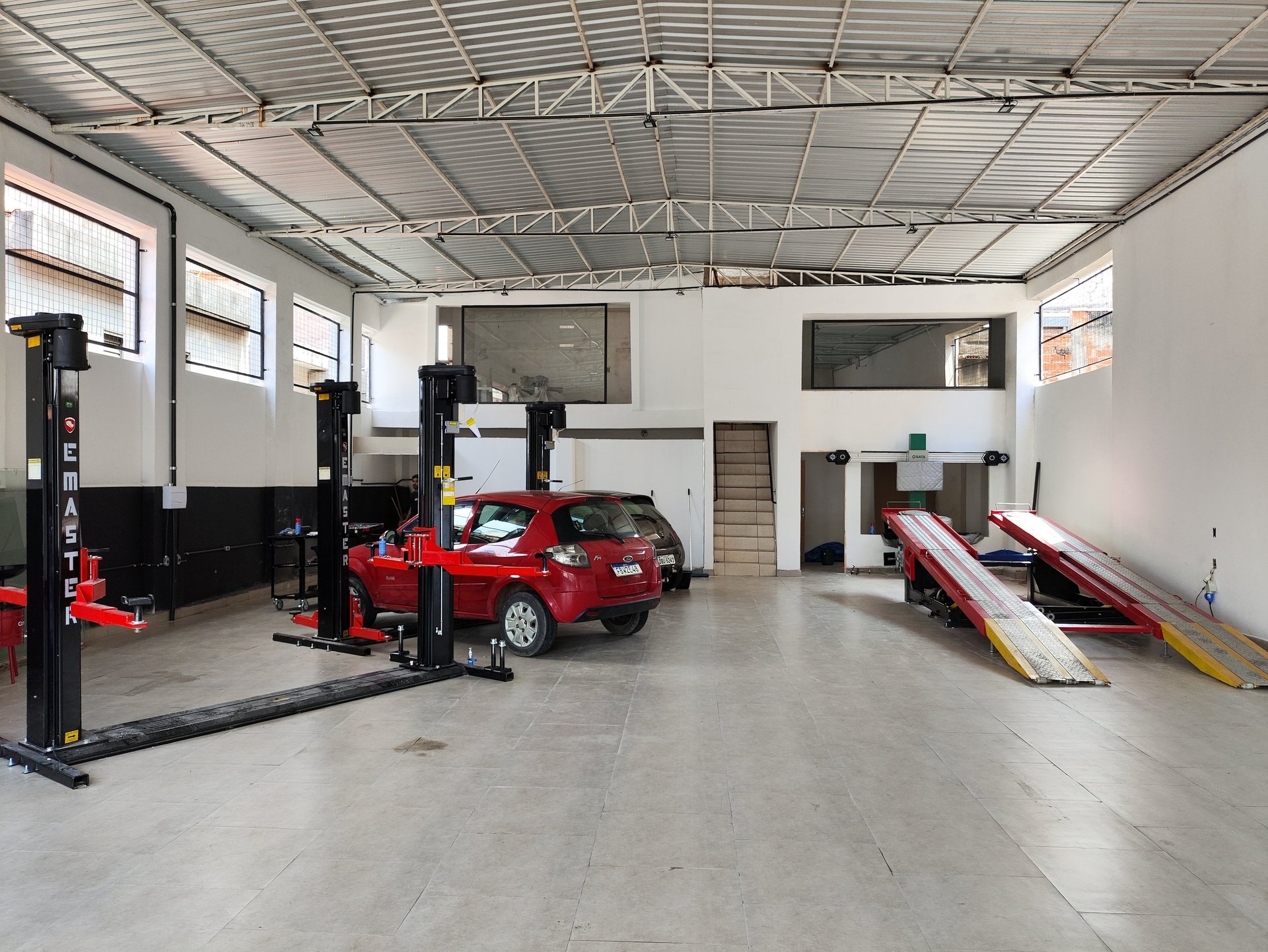 man in black jacket and blue denim jeans riding motorcycle