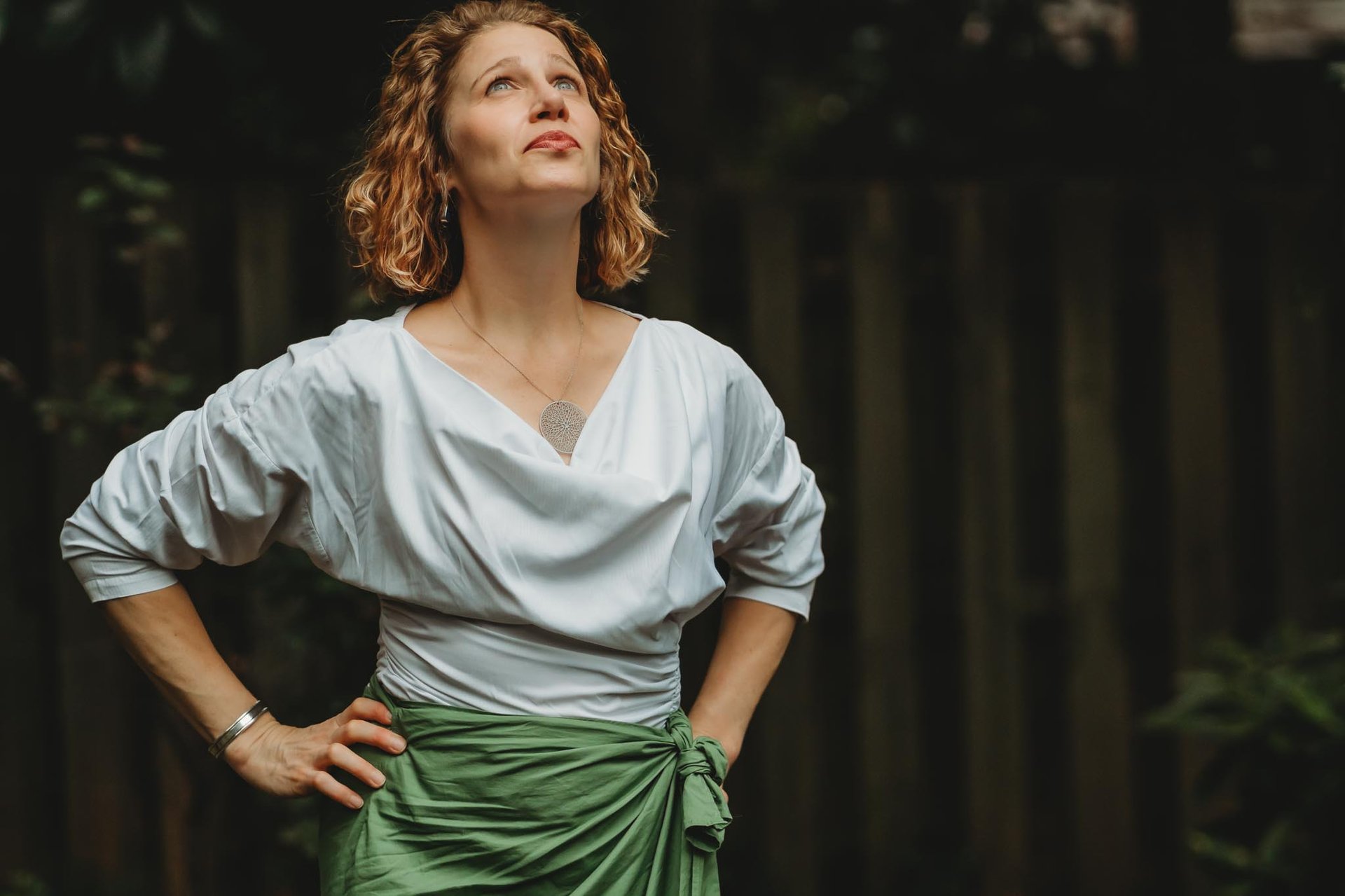 Sea Stachura with hands on hips looking upward