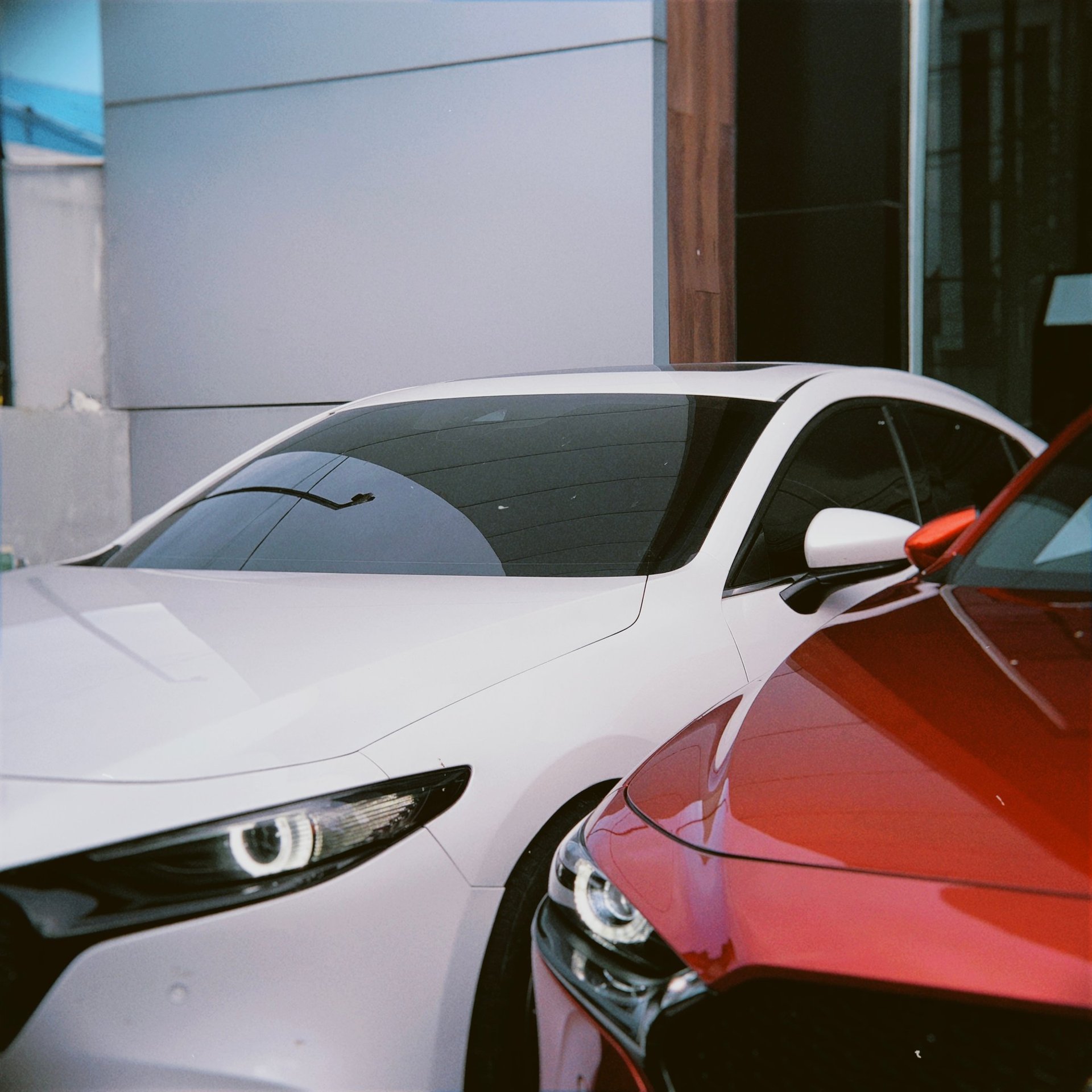 an abstract photo of a curved building with a blue sky in the background