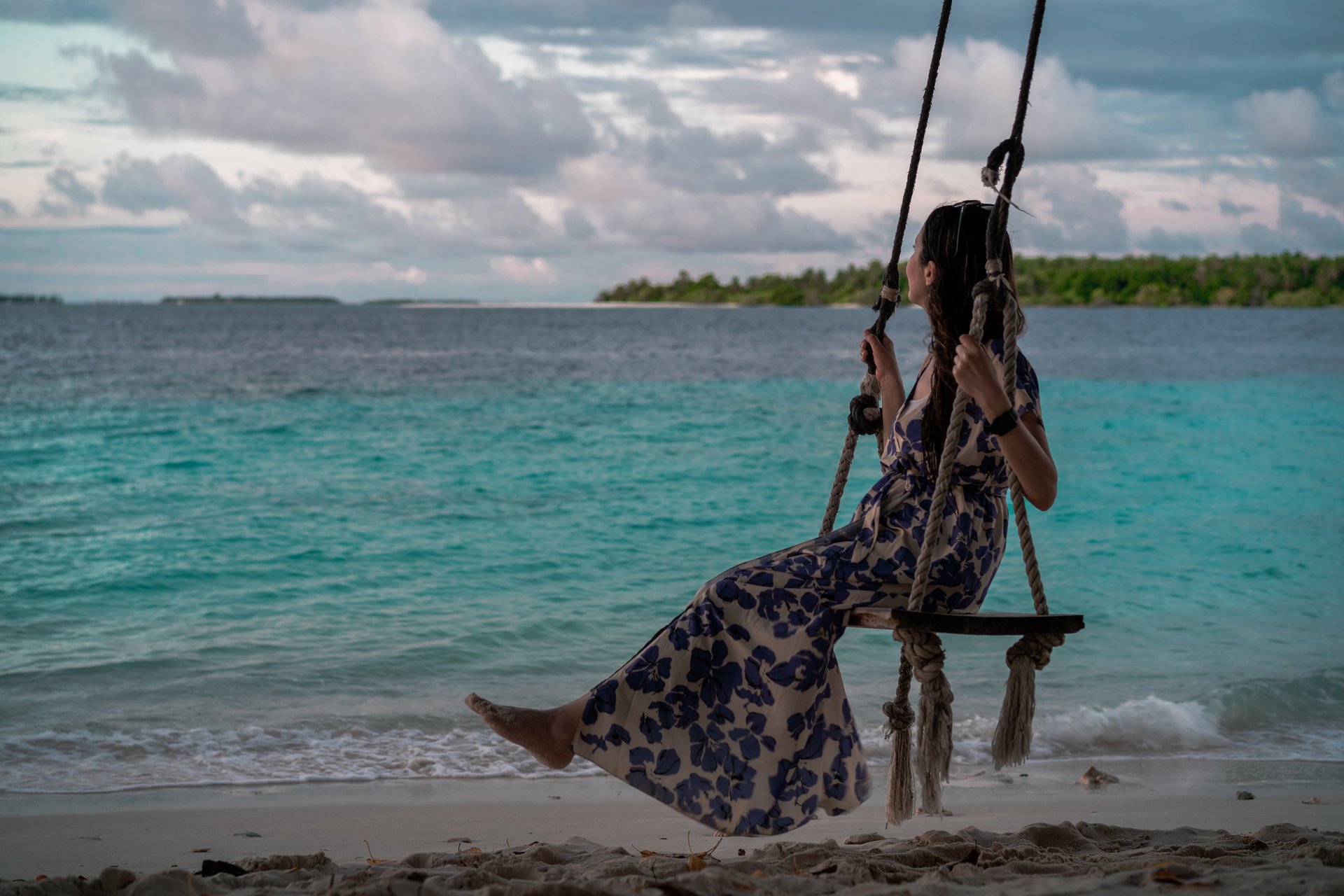 woman wearing yellow long-sleeved dress under white clouds and blue sky during daytime