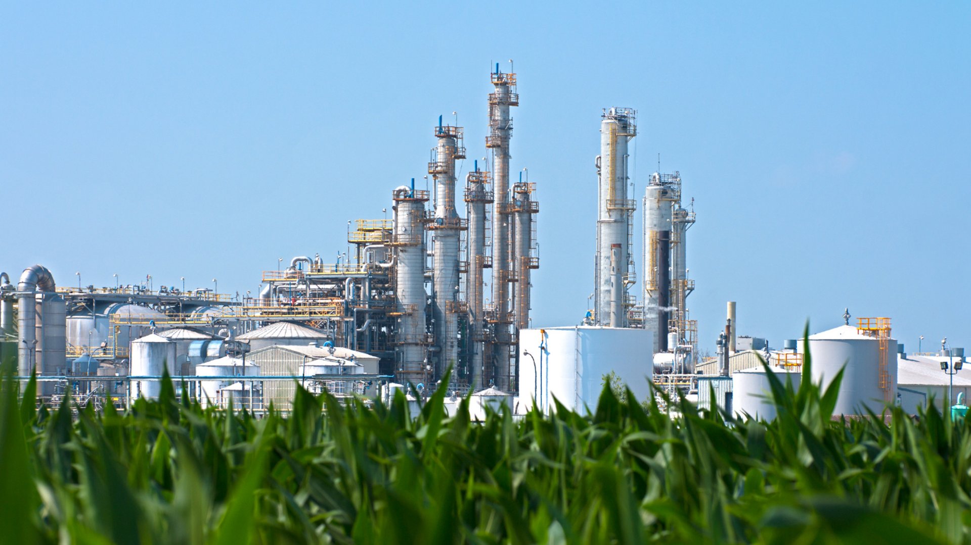 factories with smoke under cloudy sky