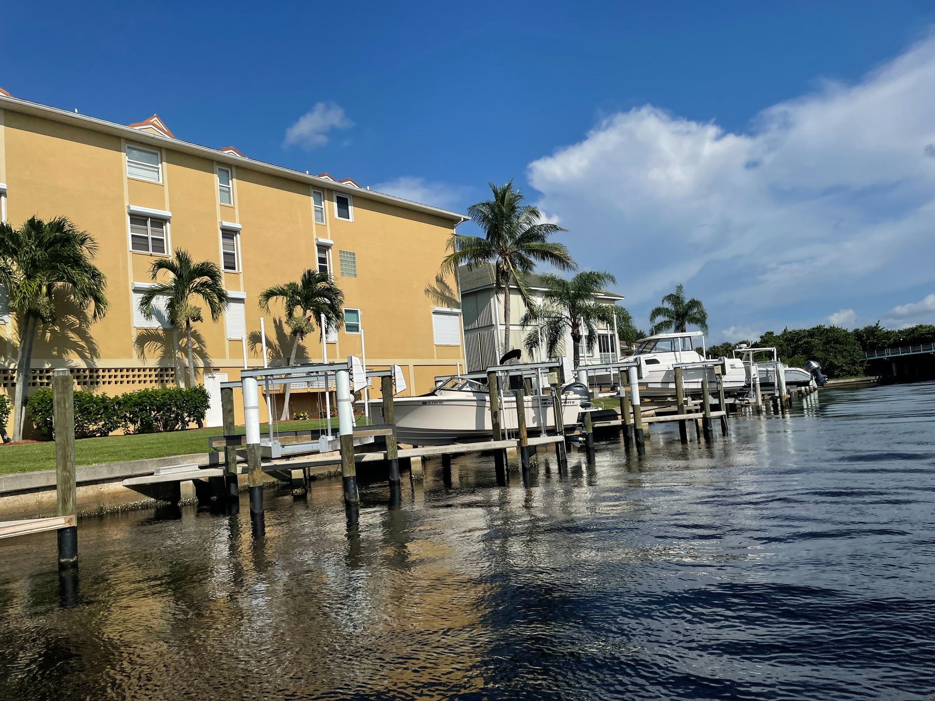 woman wearing yellow long-sleeved dress under white clouds and blue sky during daytime