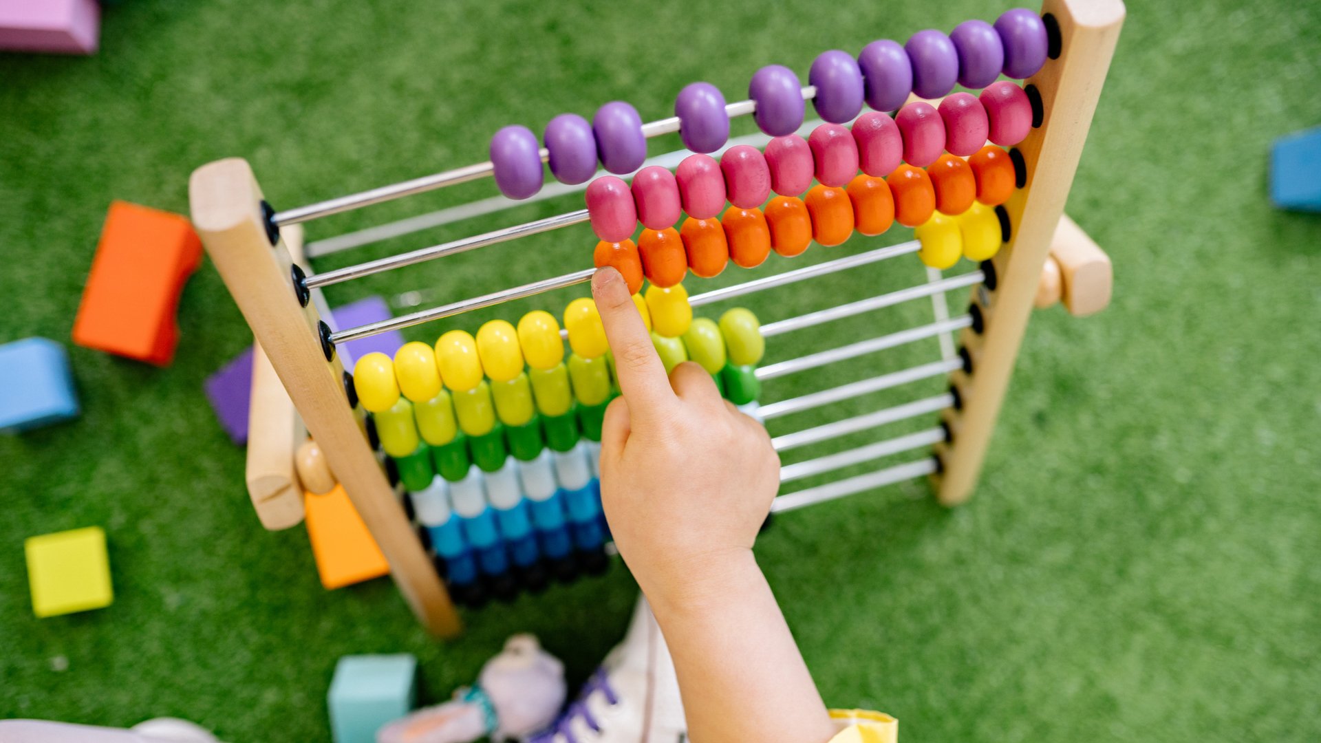 a child is playing with a wooden toy