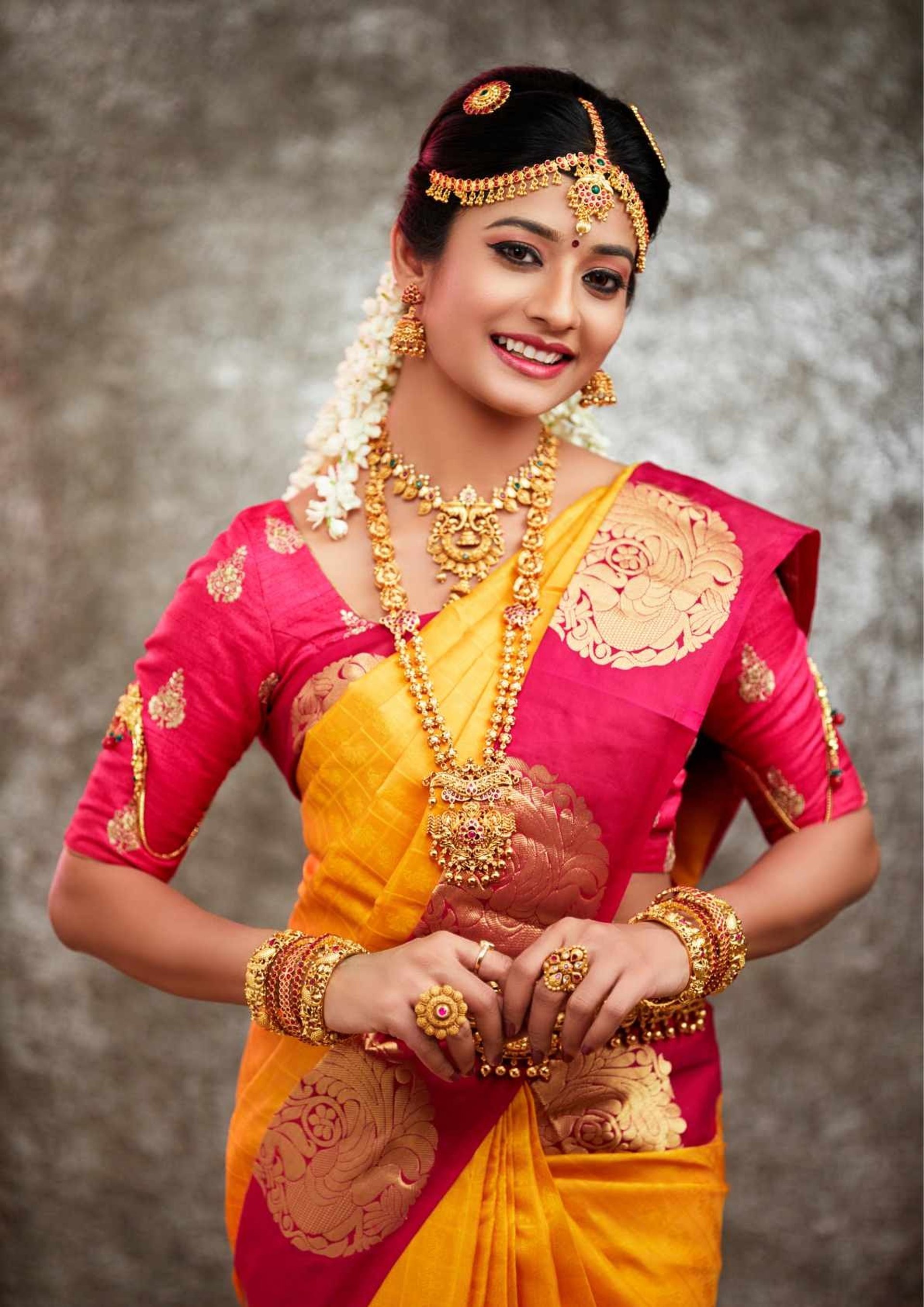 woman in white long-sleeved shirt standing in front of pink wall