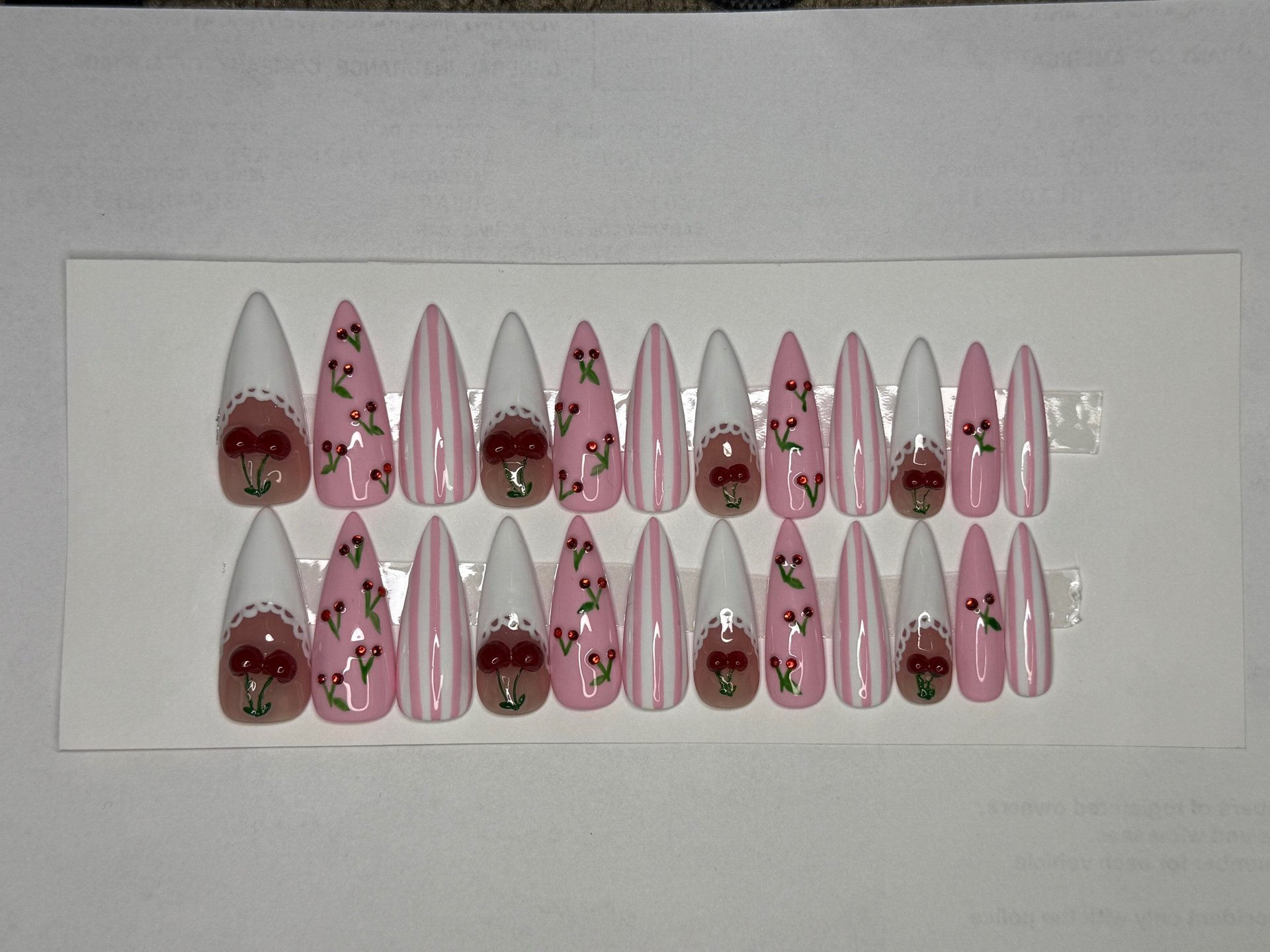 a woman's hands with white manicures and a ring