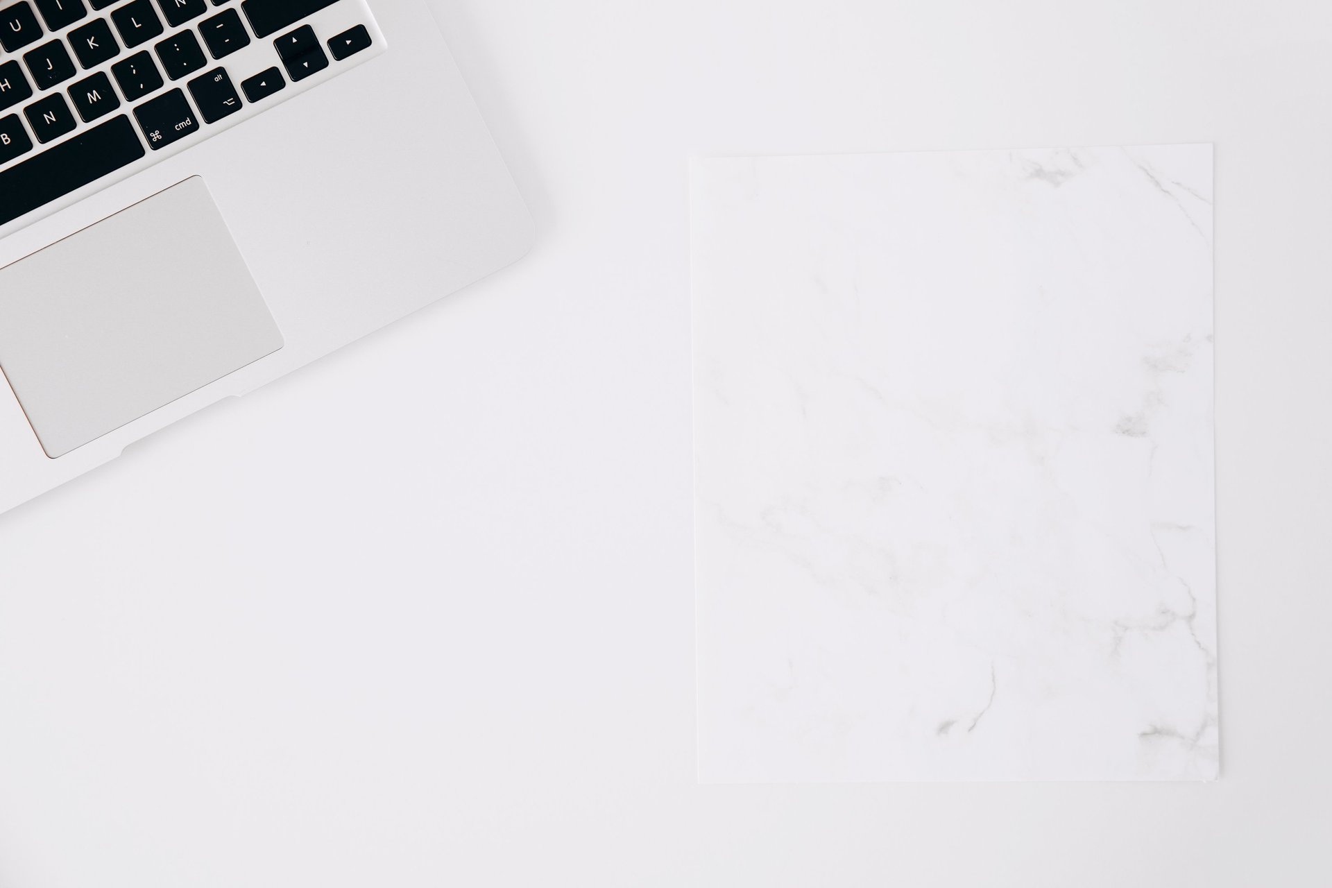 gray and black wooden bridge across mountains covered by trees