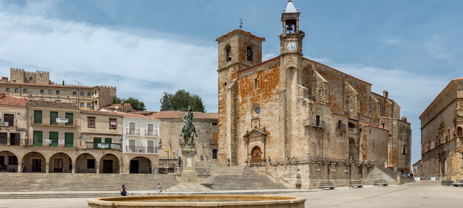 a narrow street with a stone archway between two buildings