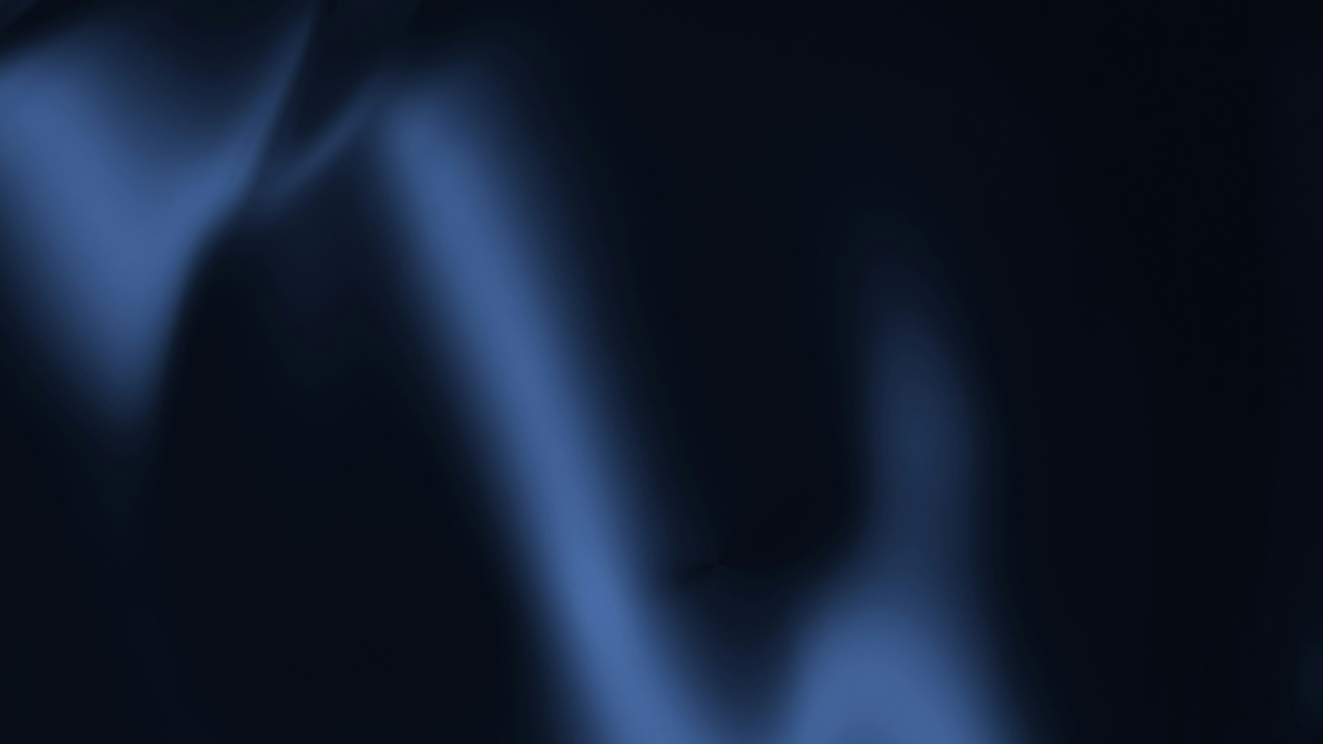 an abstract photo of a curved building with a blue sky in the background