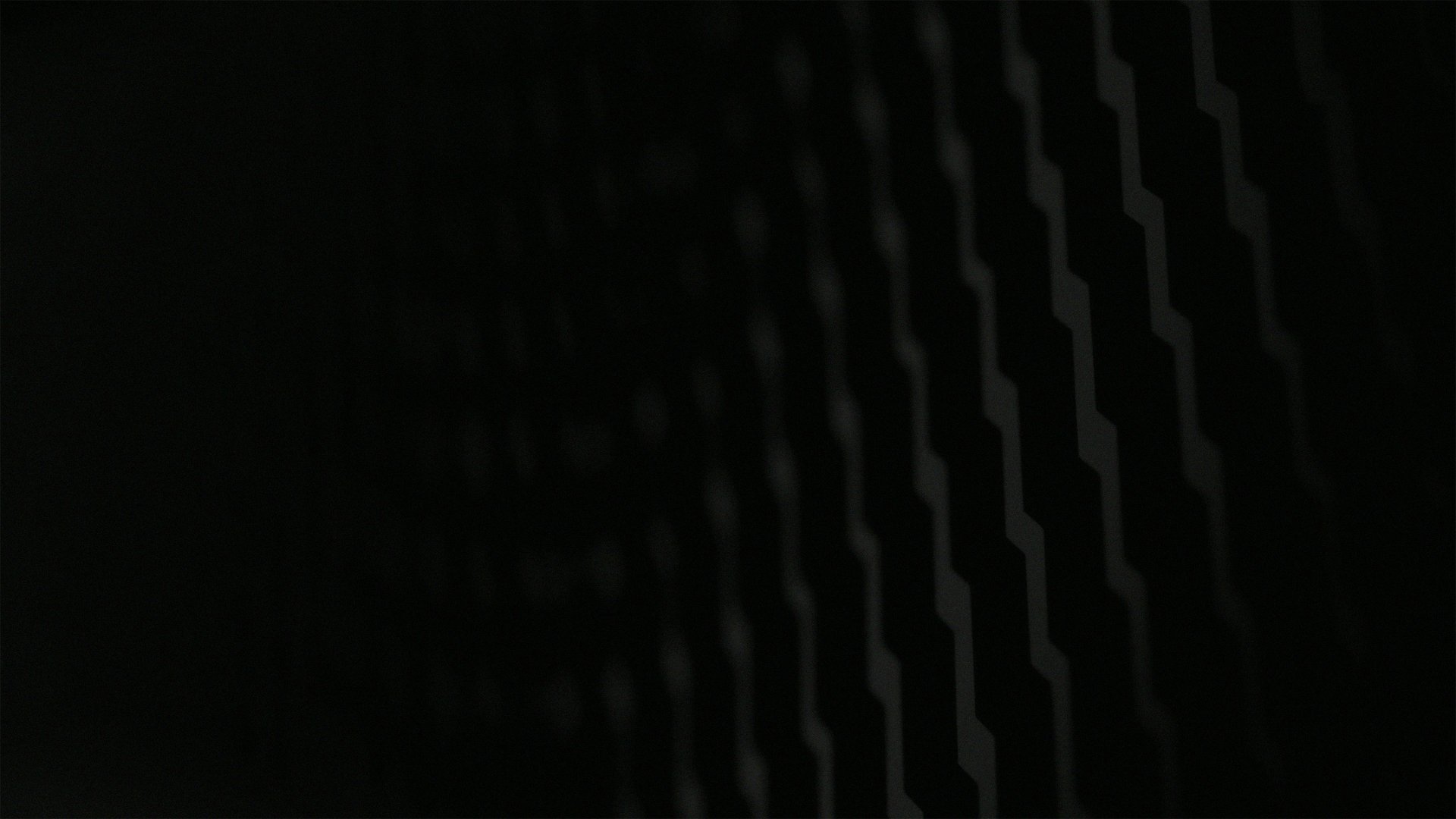 an abstract photo of a curved building with a blue sky in the background