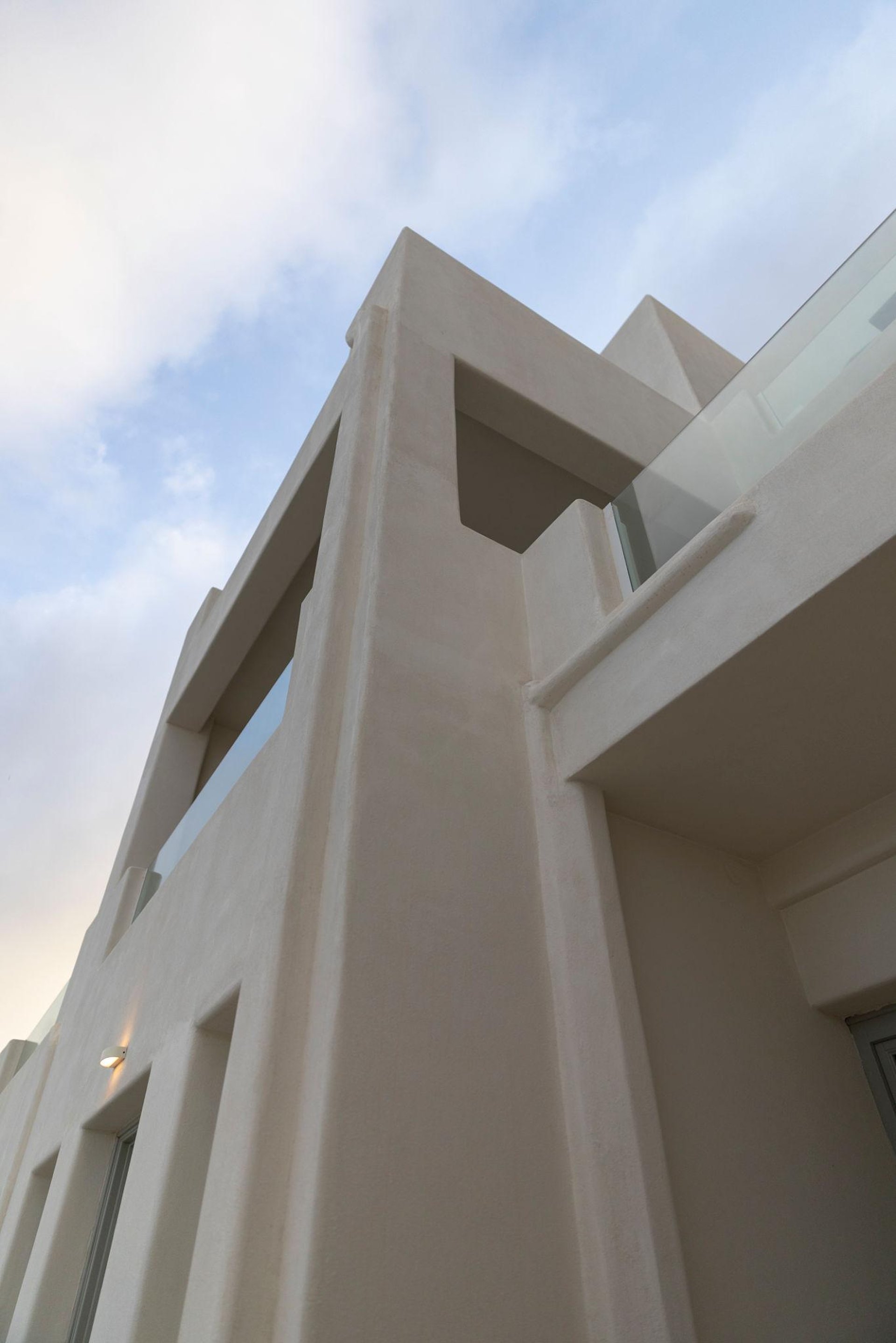 Exterior of a modern luxury home captured at sunset. Warm, subtle outdoor highlights architectural lines and light surfaces