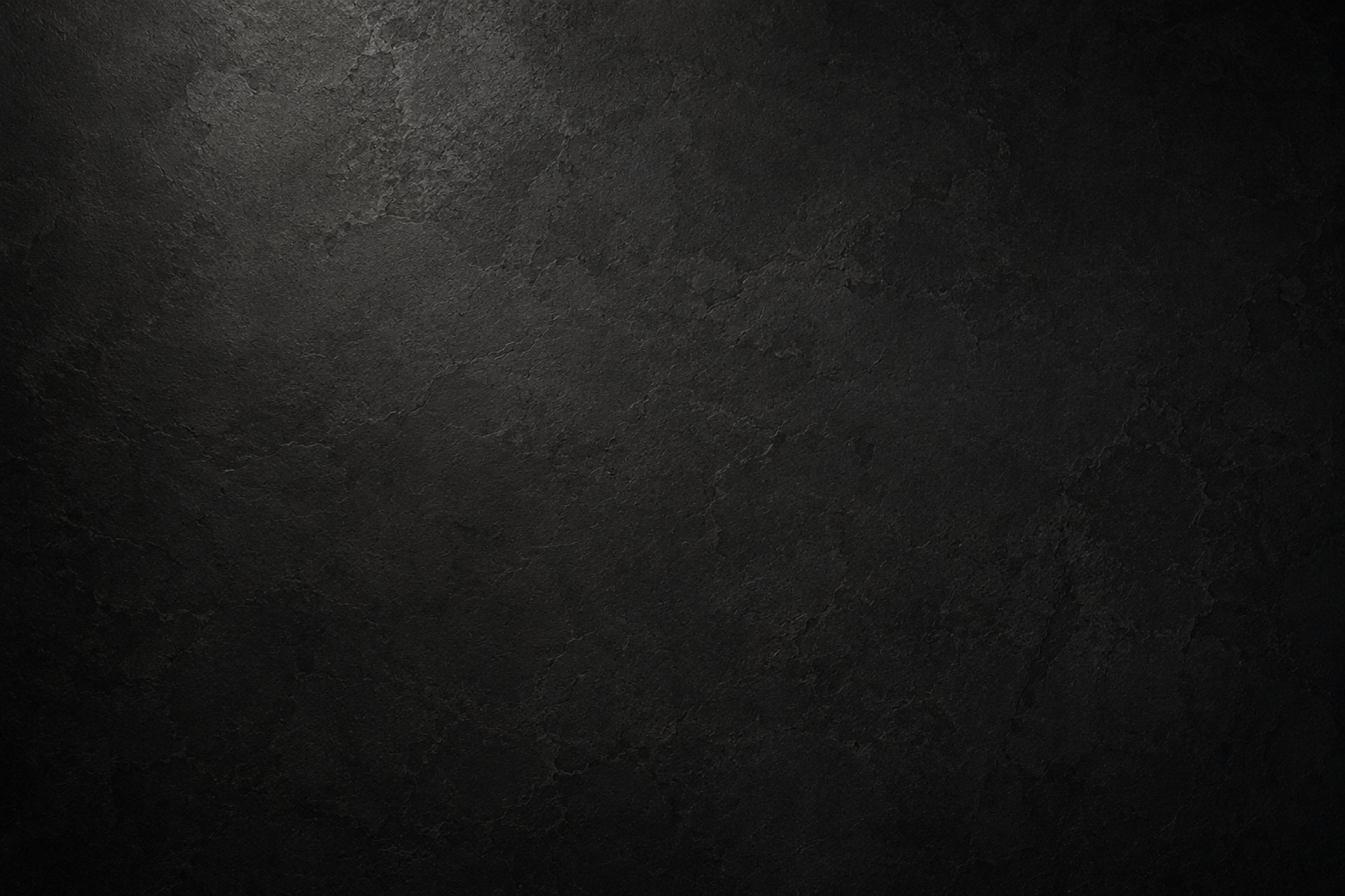 Dark textured architectural stone surface with subtle lighting, creating a refined backdrop for strategic partnership content