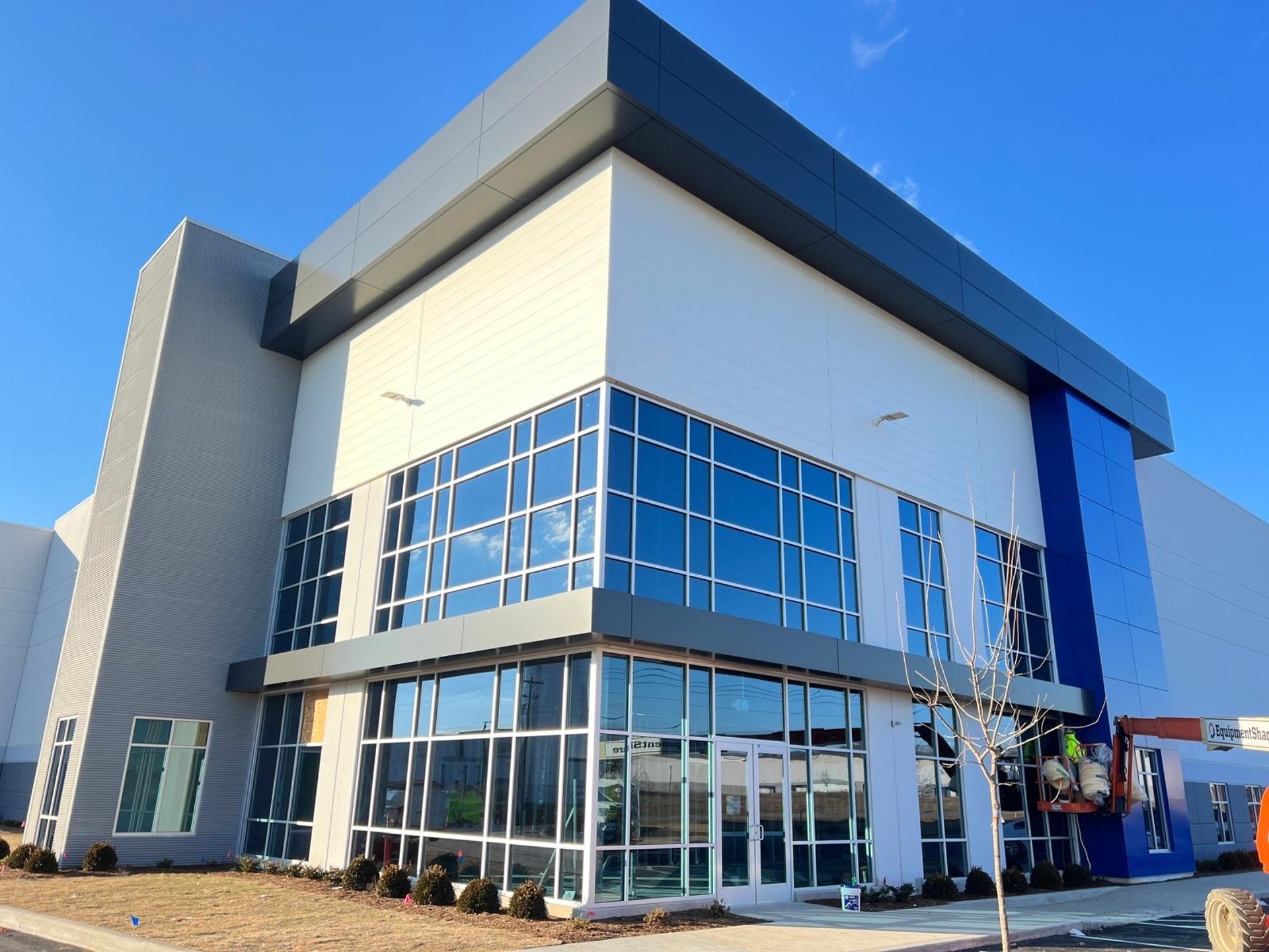 an abstract photo of a curved building with a blue sky in the background