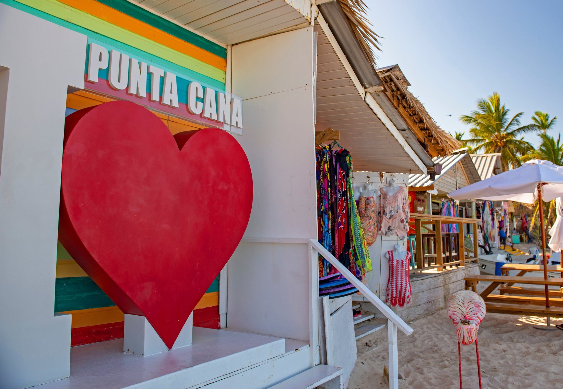 Colorful Punta Cana beach market with "I ❤️ Punta Cana" sign and tropical souvenirs