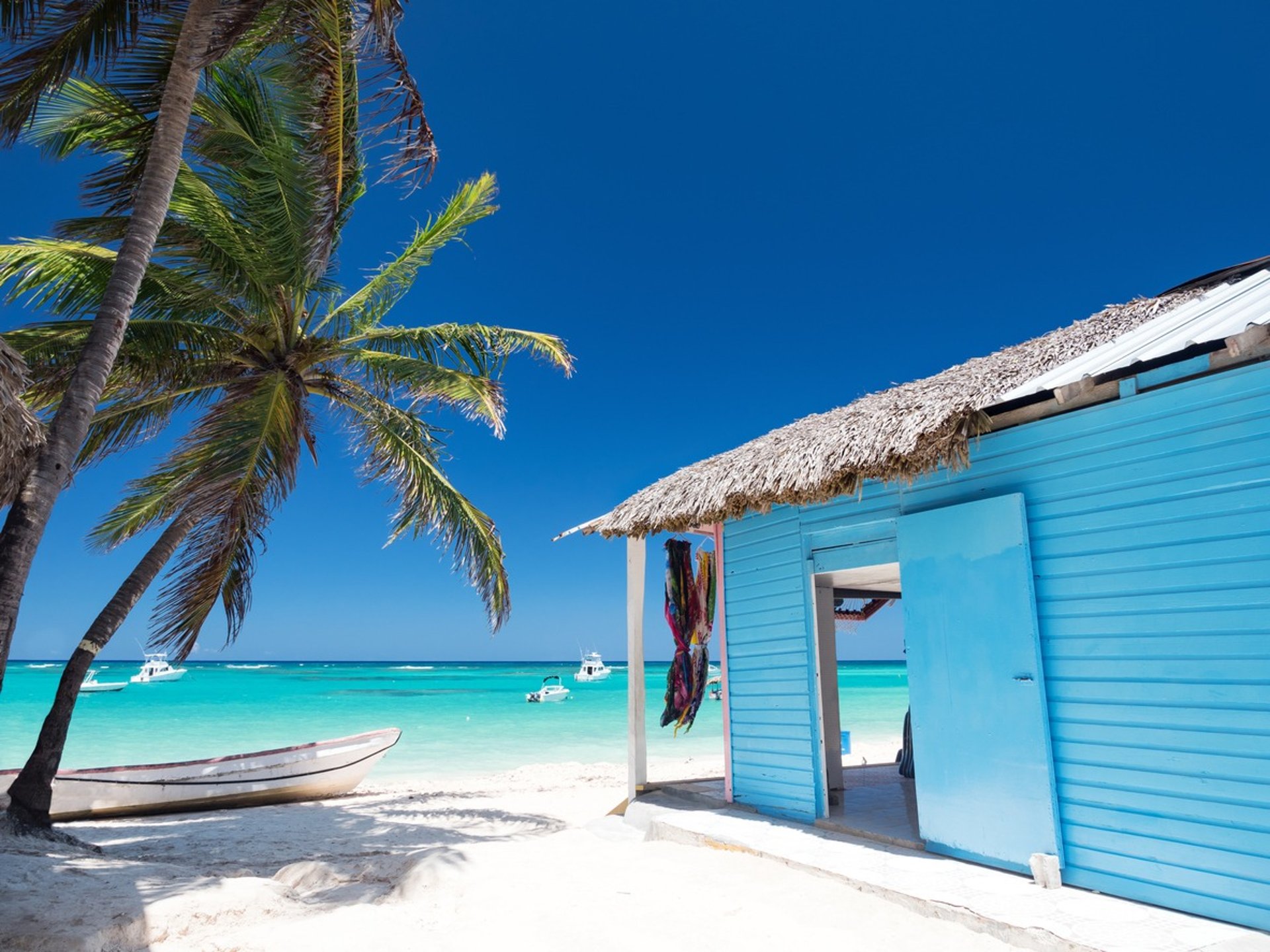 Beach hut on white sand with palm trees and turquoise water in Punta Cana, Dominican Republic