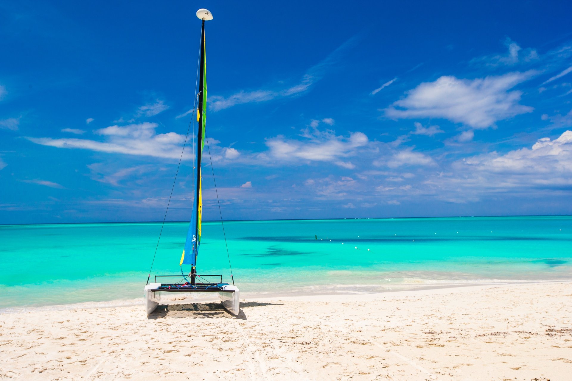 Catamaran on white sand beach with turquoise water in the Dominican Republic