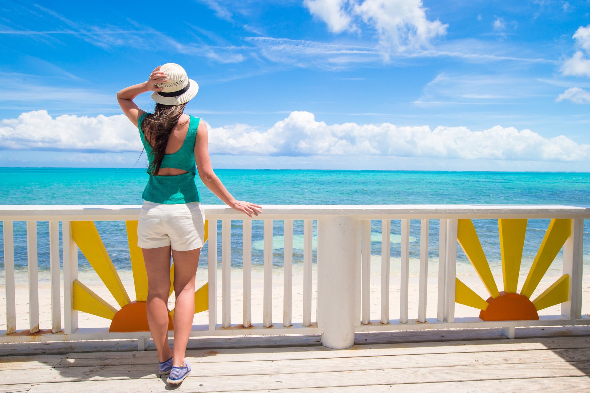 Woman enjoying ocean view on a sunny deck in the Dominican Republic