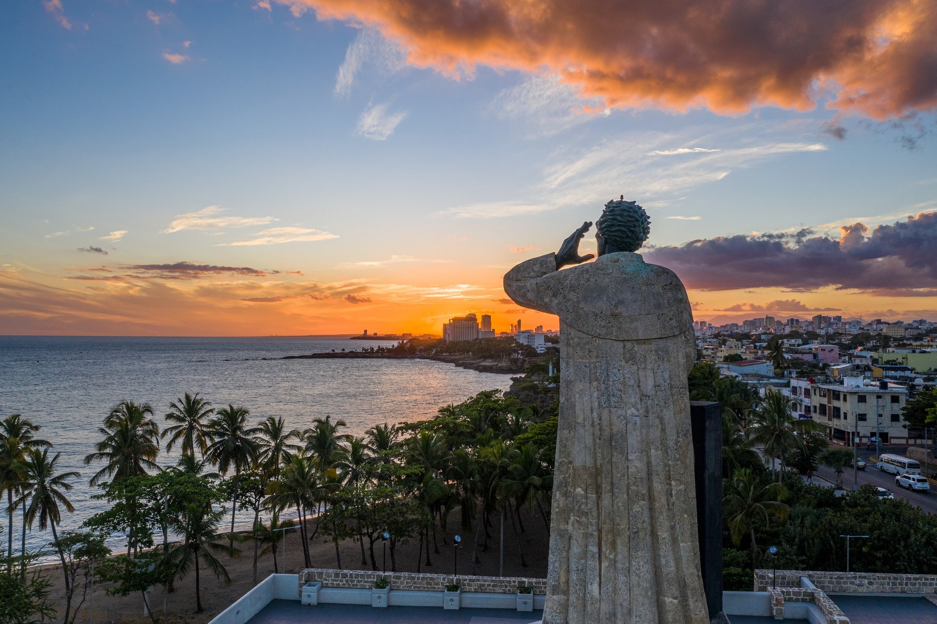 Statue of Fray Antón de Montesinos overlooking Santo Domingo Malecón at sunset