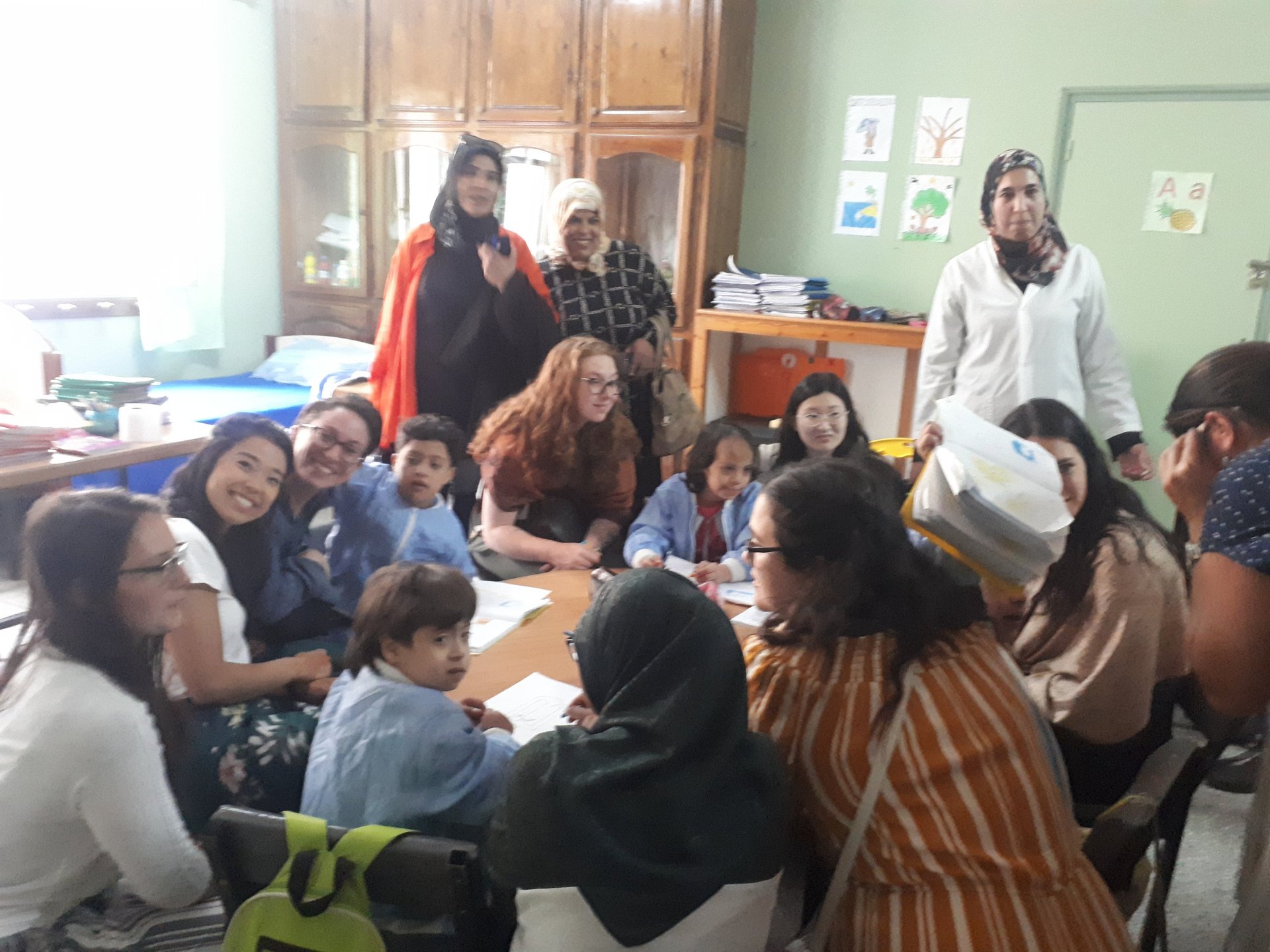 Narrow street lined with shops and people