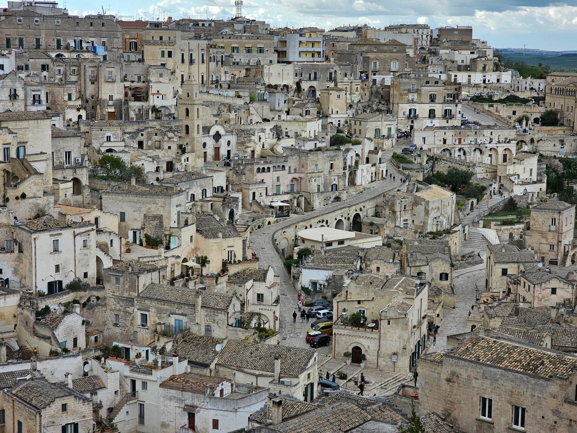 woman wearing yellow long-sleeved dress under white clouds and blue sky during daytime